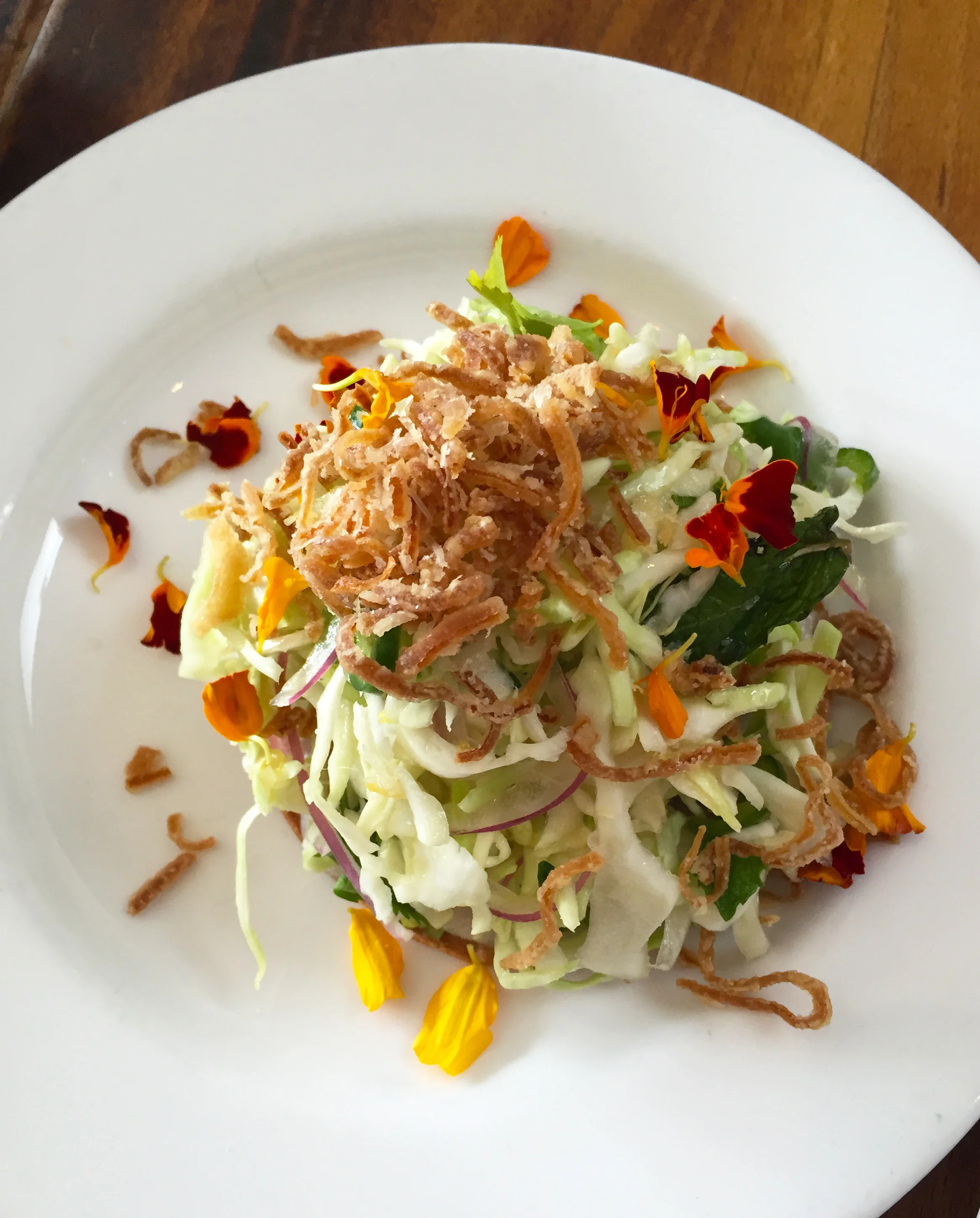 Hamachi tostada with fish sauce vinaigrette, peanut, and avocado.