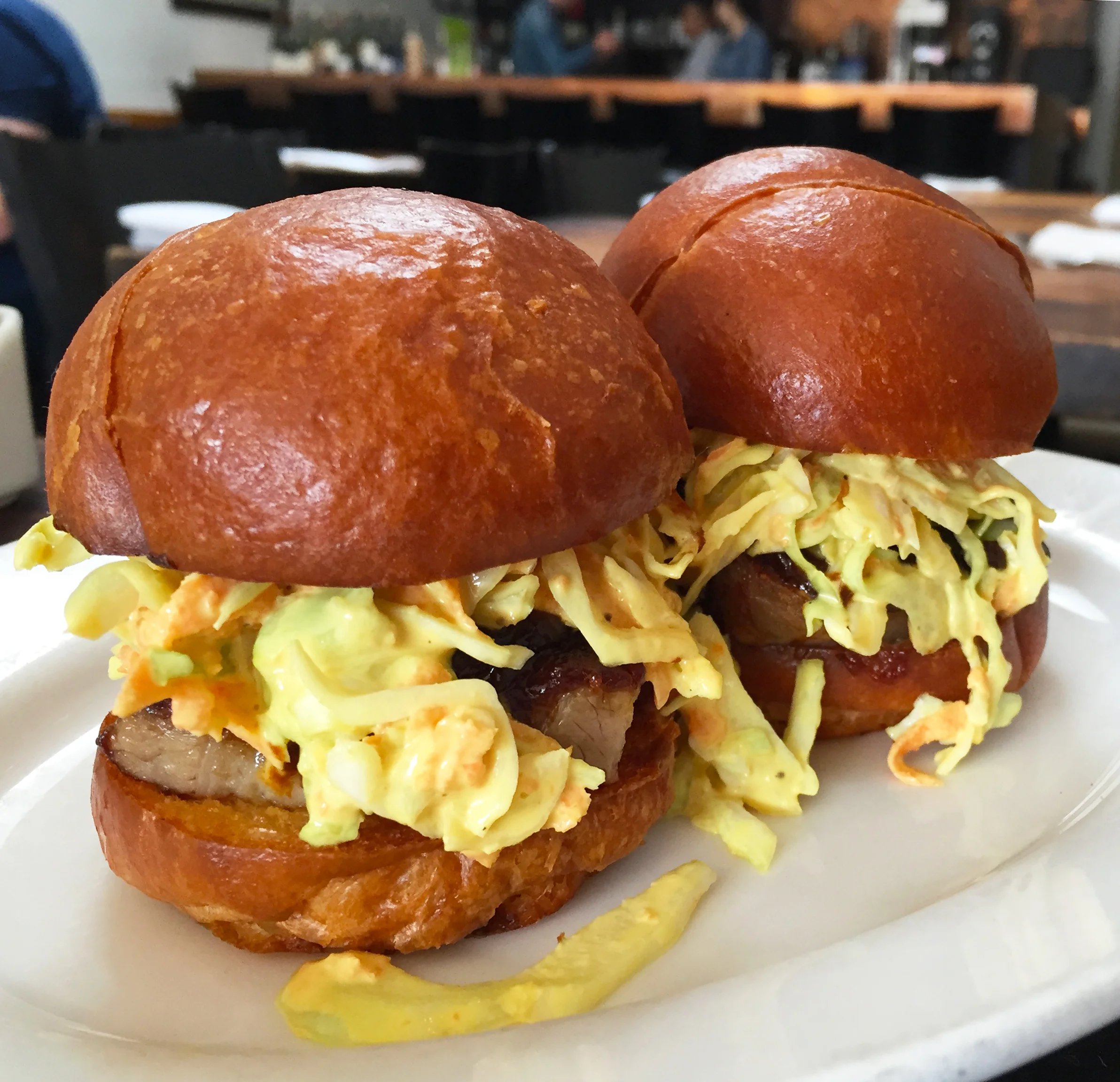Barbeque pork belly sandwiches with slaw.