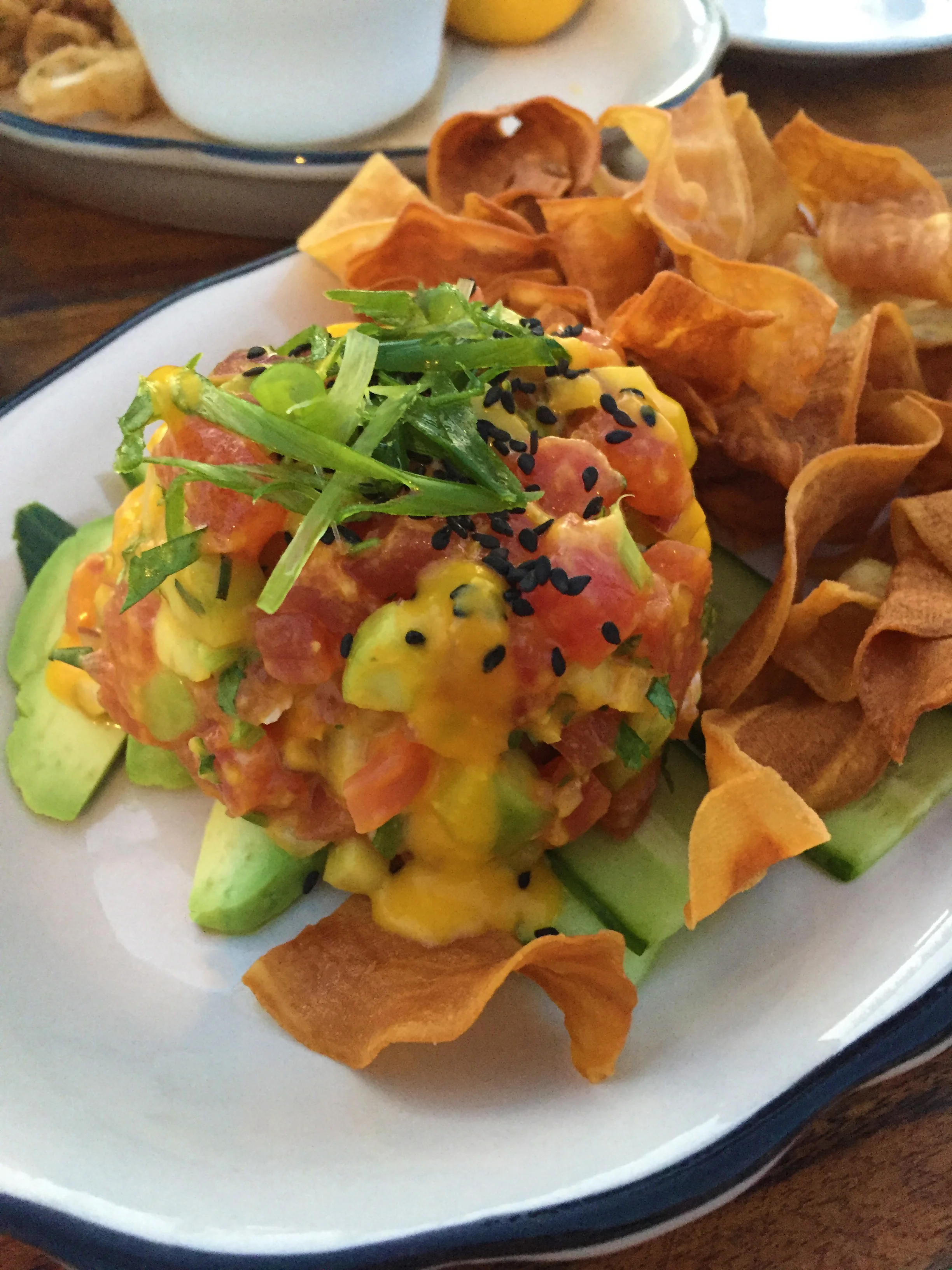 Tuna Tartare with ginger lime marinade, cilantro, avocado, and boniato chips.