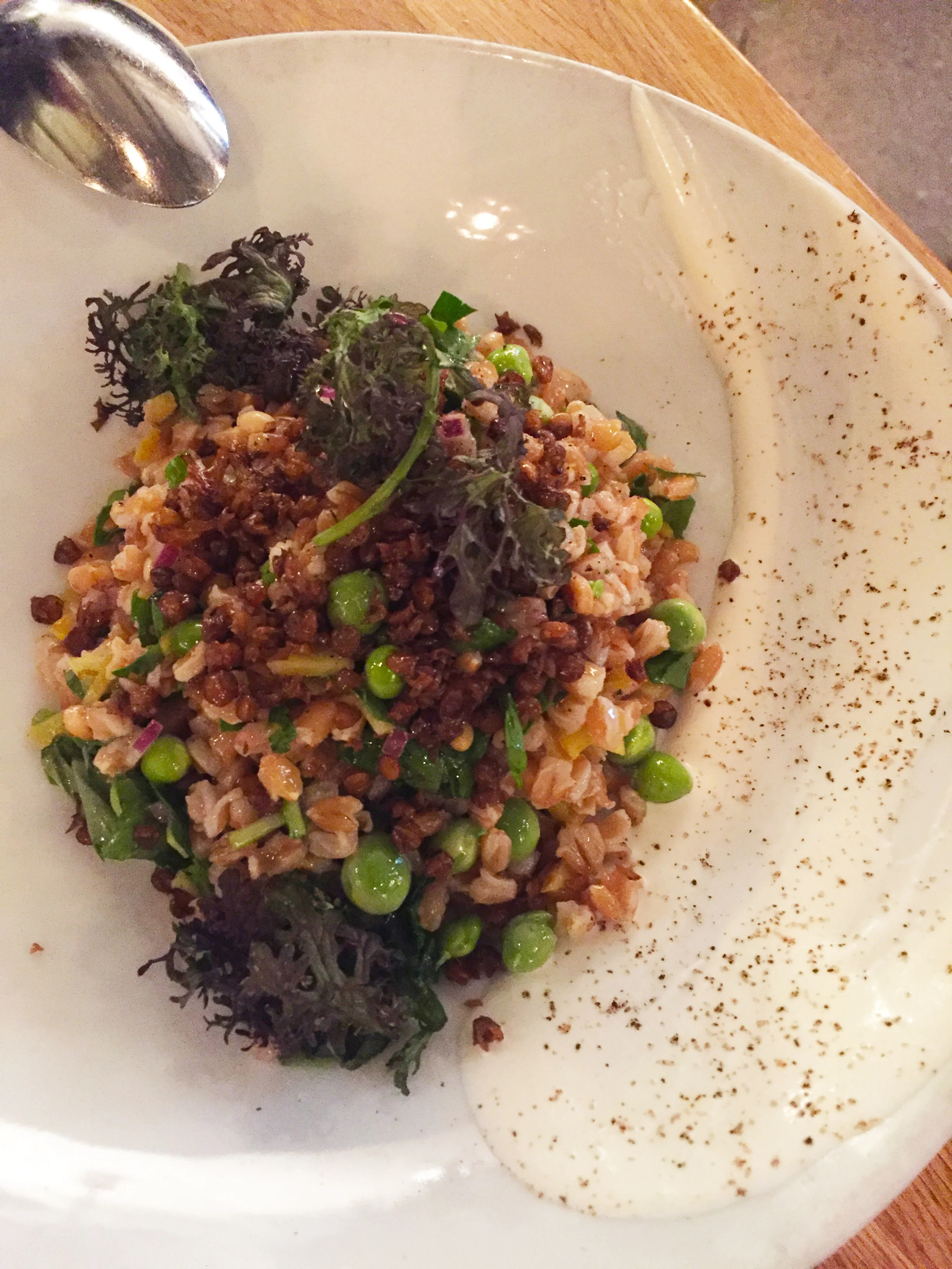 Farro Salad with crème fraîche, English peas, pine nuts, pickled sunchokes, fried lentils, and herbs.