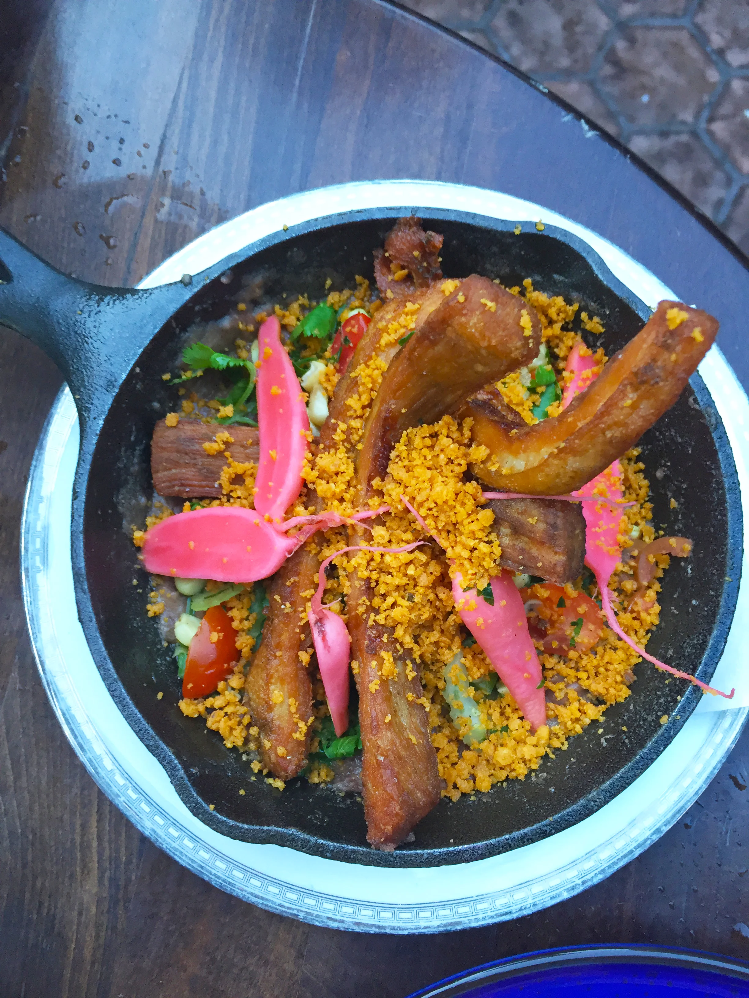 Crispy Pork Cheek Carnitas with Pickled Radish, Refried Red Beans, Maque Choux Salsa, & Frito Pie Crumble