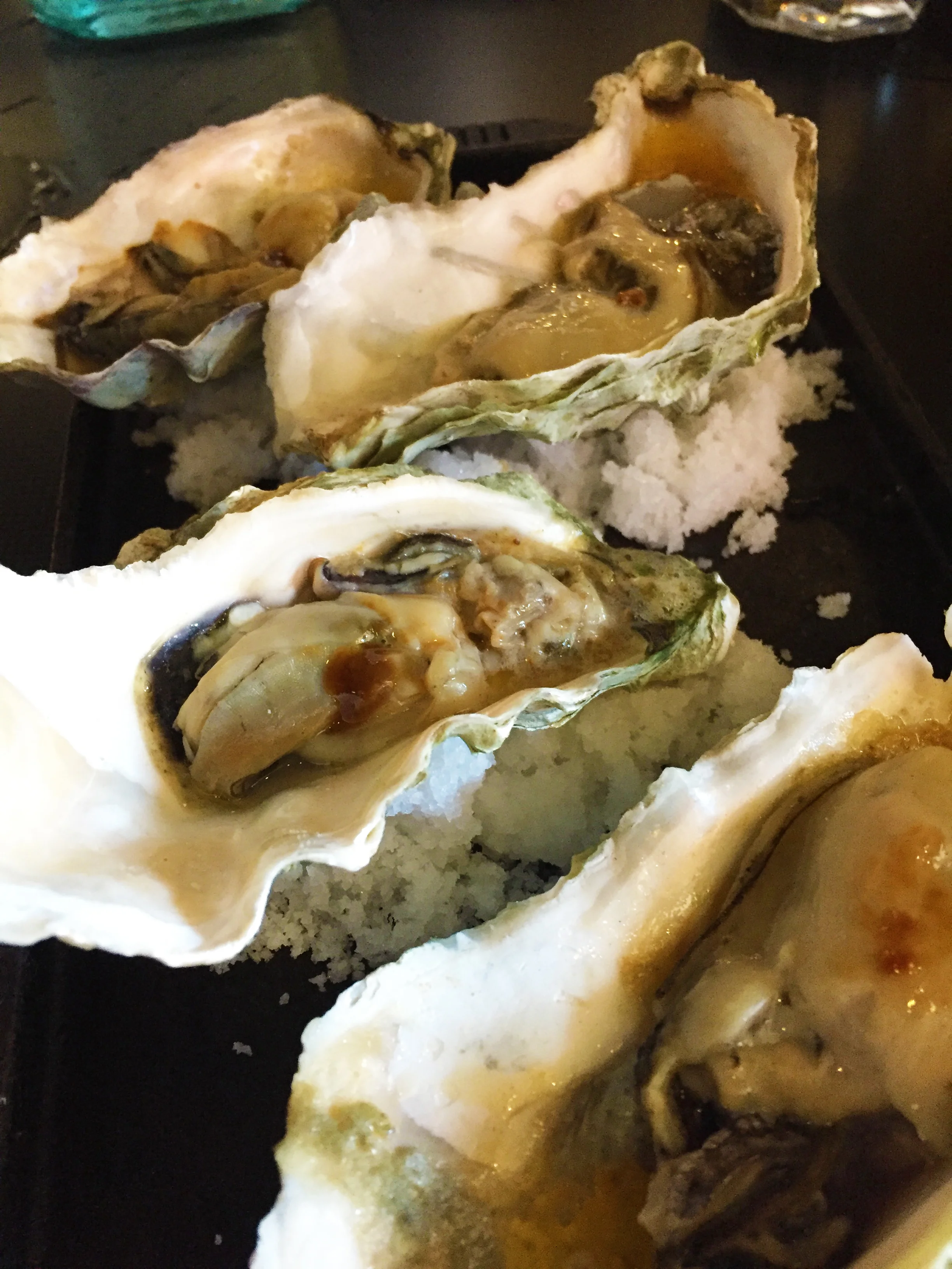 Grilled West Coast Oysters with Old Bay garlic butter.