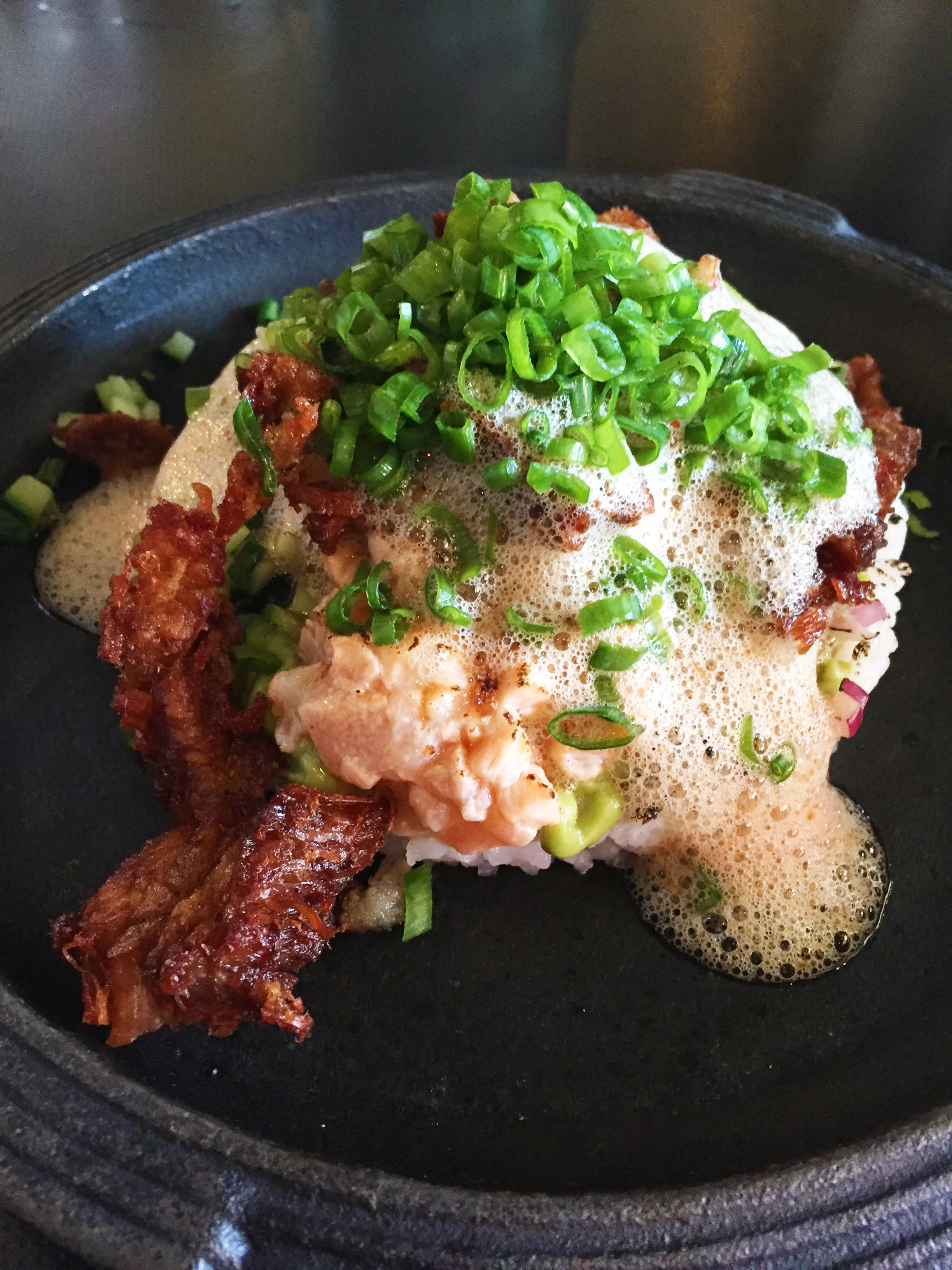 Dirty Rice with sushi rice, crispy pork belly, and salmon sashimi.
