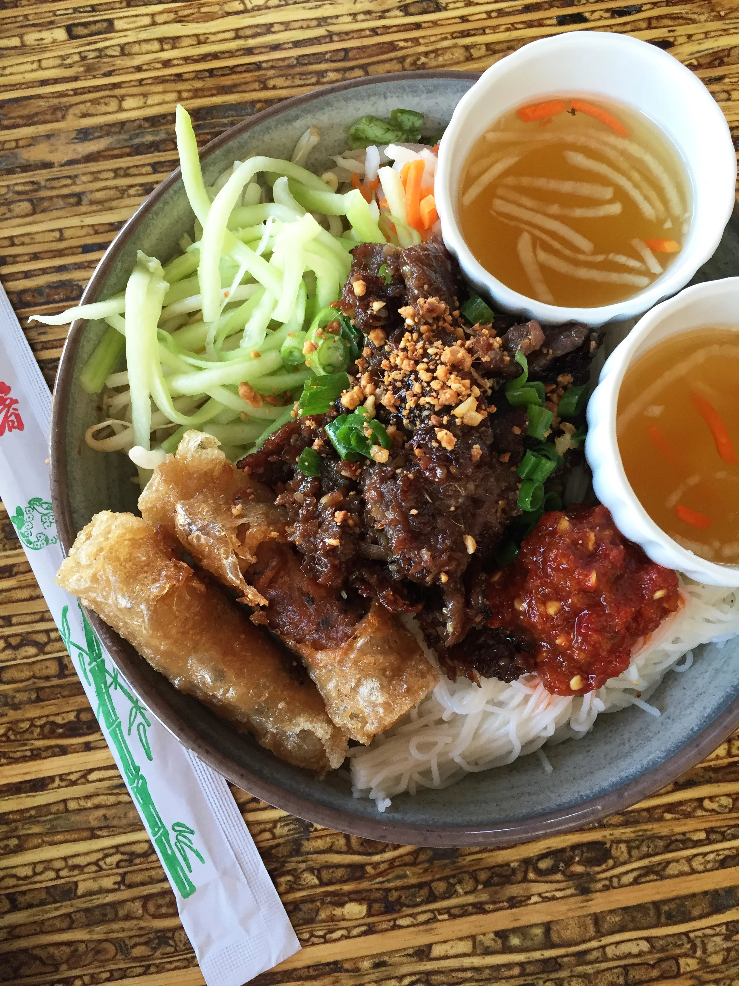 Bun Noodle Bowl with Beef Rib Eye, vermicelli, red leaf lettuce, mint, perilla, cucumbers, bean sprouts, pickled root vegetables, nuoc cham, and Imperial rolls (filled with crab and shrimp!).
