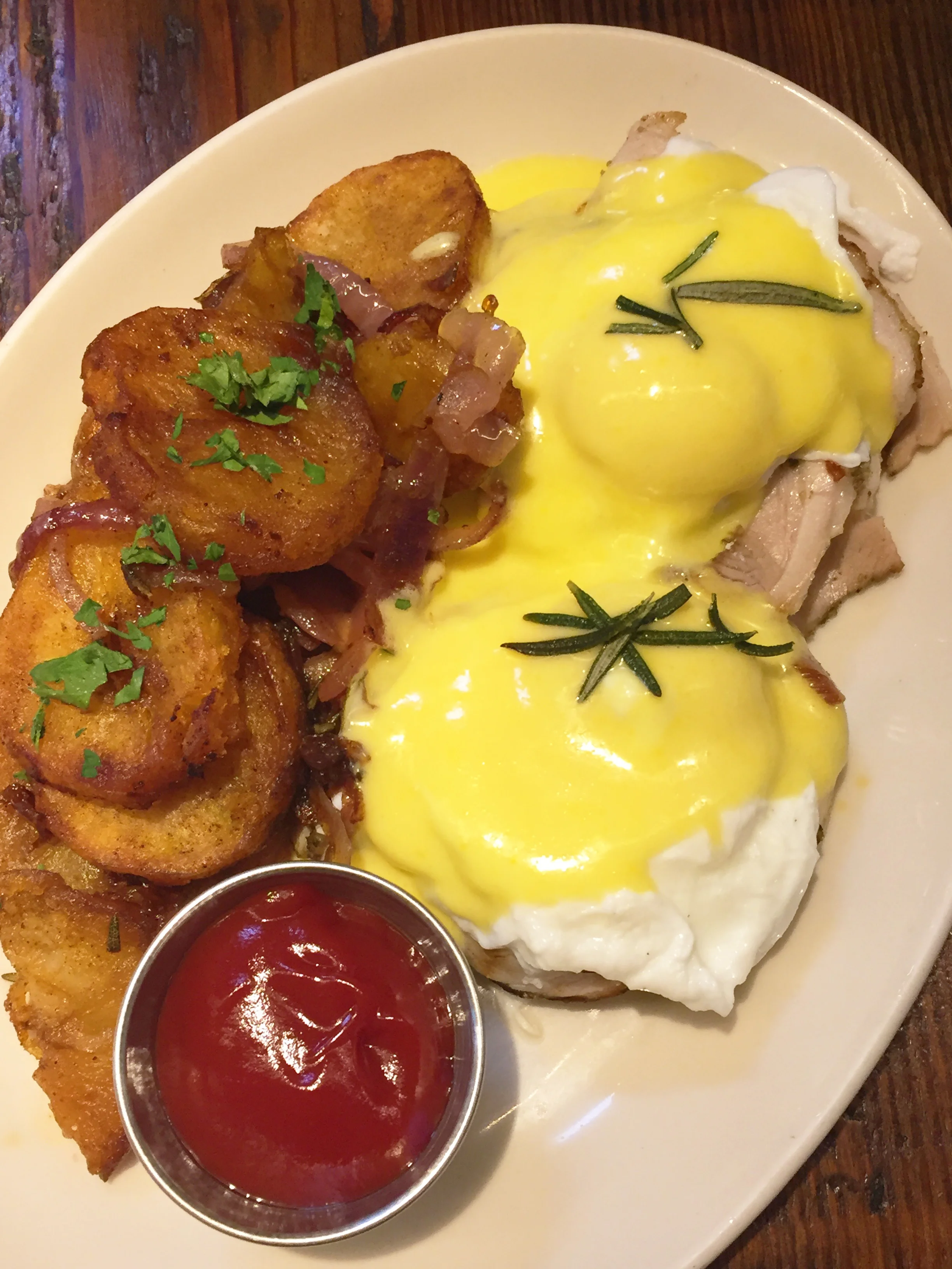 Porchetta eggs benedict, housemade english muffin, hollandaise, breakfast potatoes