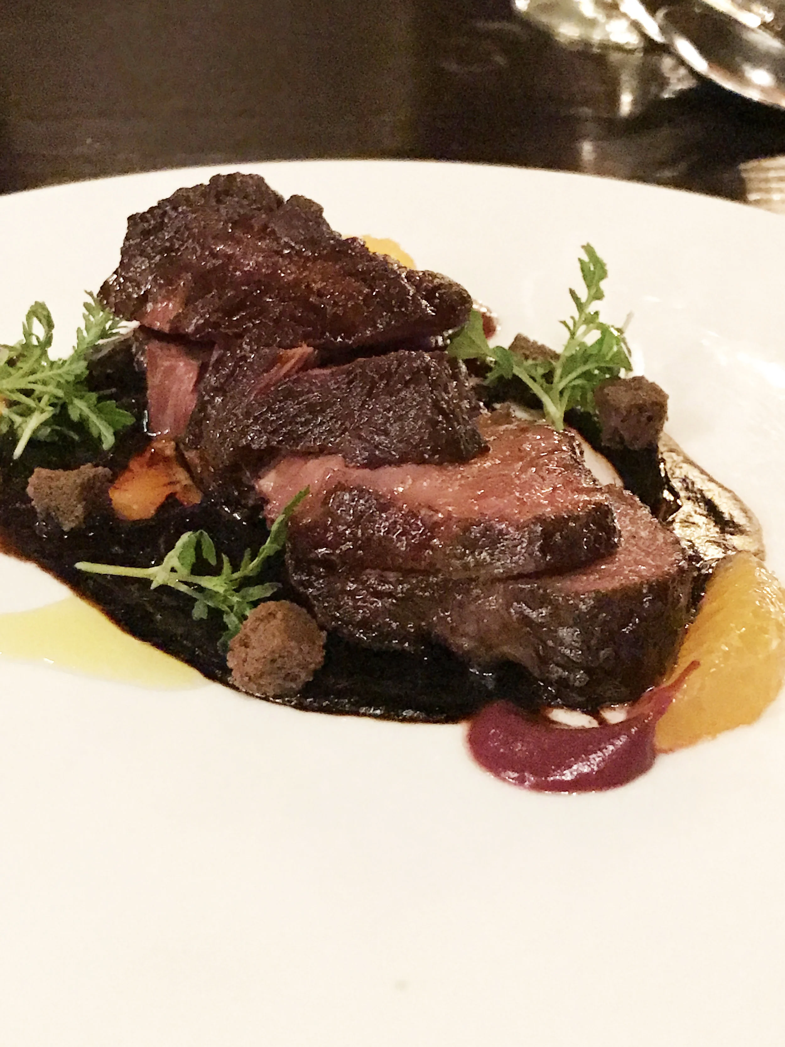 Seared Wagyu Beef Cheeks with black garlic, cherries, and black olive