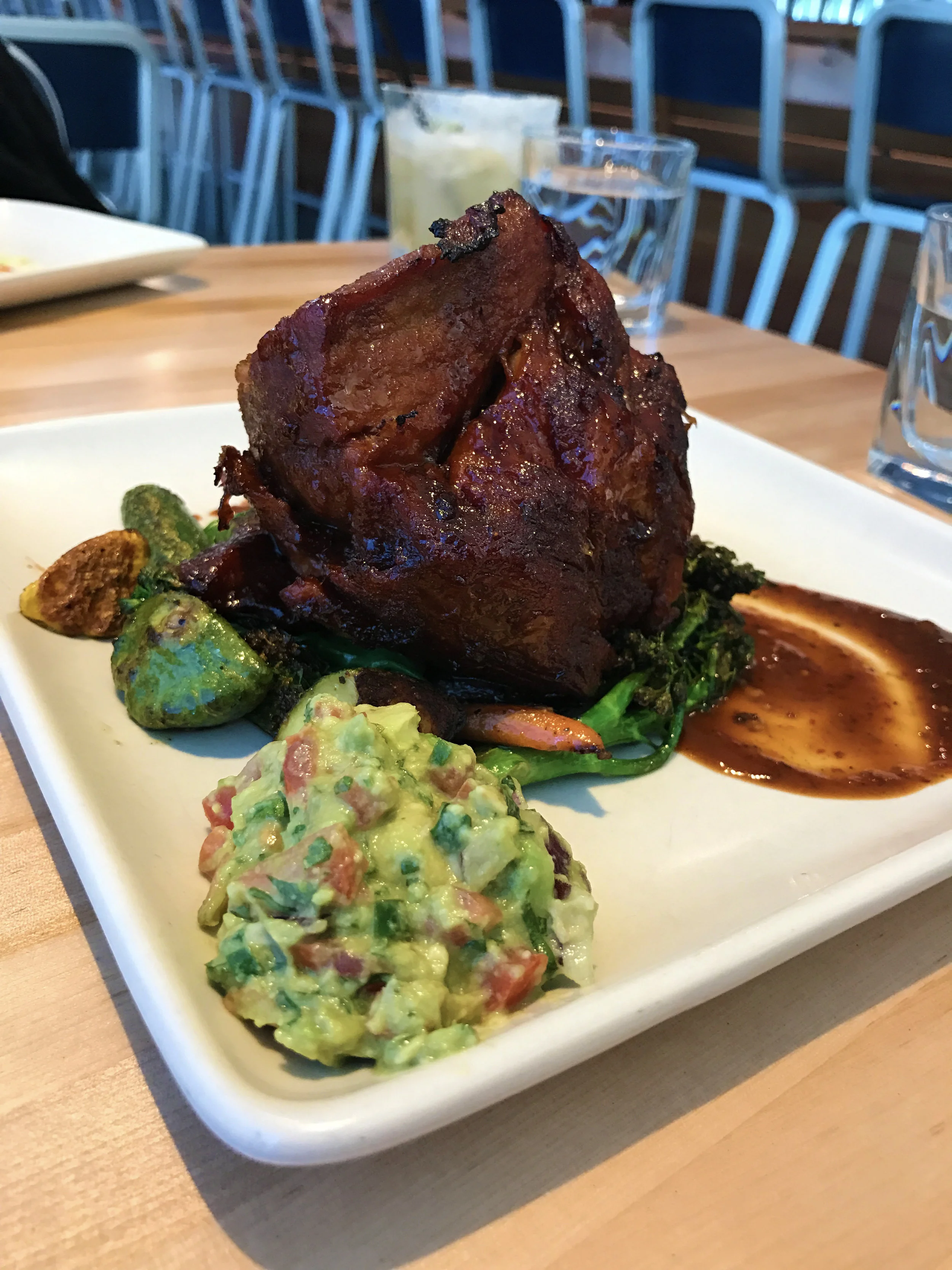 Chef Jose’s Carnitas - slow-cooked natural pork, guacamole, Yxta salsa brava, with market vegetables and tortillas