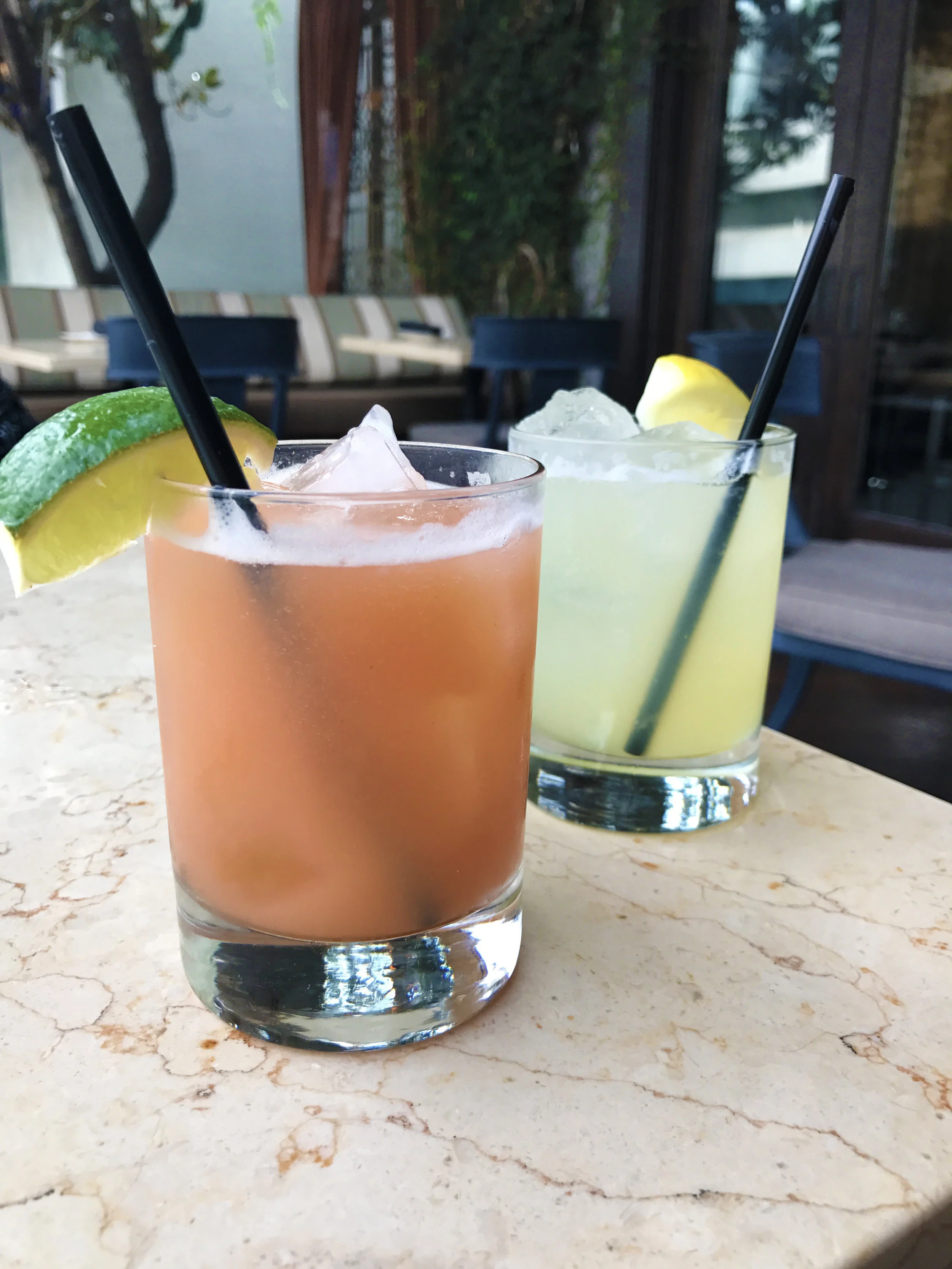 (front) The Guara Rita with Avion Tequila Blanco, organic guava agave, fresh lime, kaffir lime leaf tincture, and kaffir lime leaf salt (back) Gimlet with Loft & Bear Vodka, fresh lime, organic agave, and lime zest