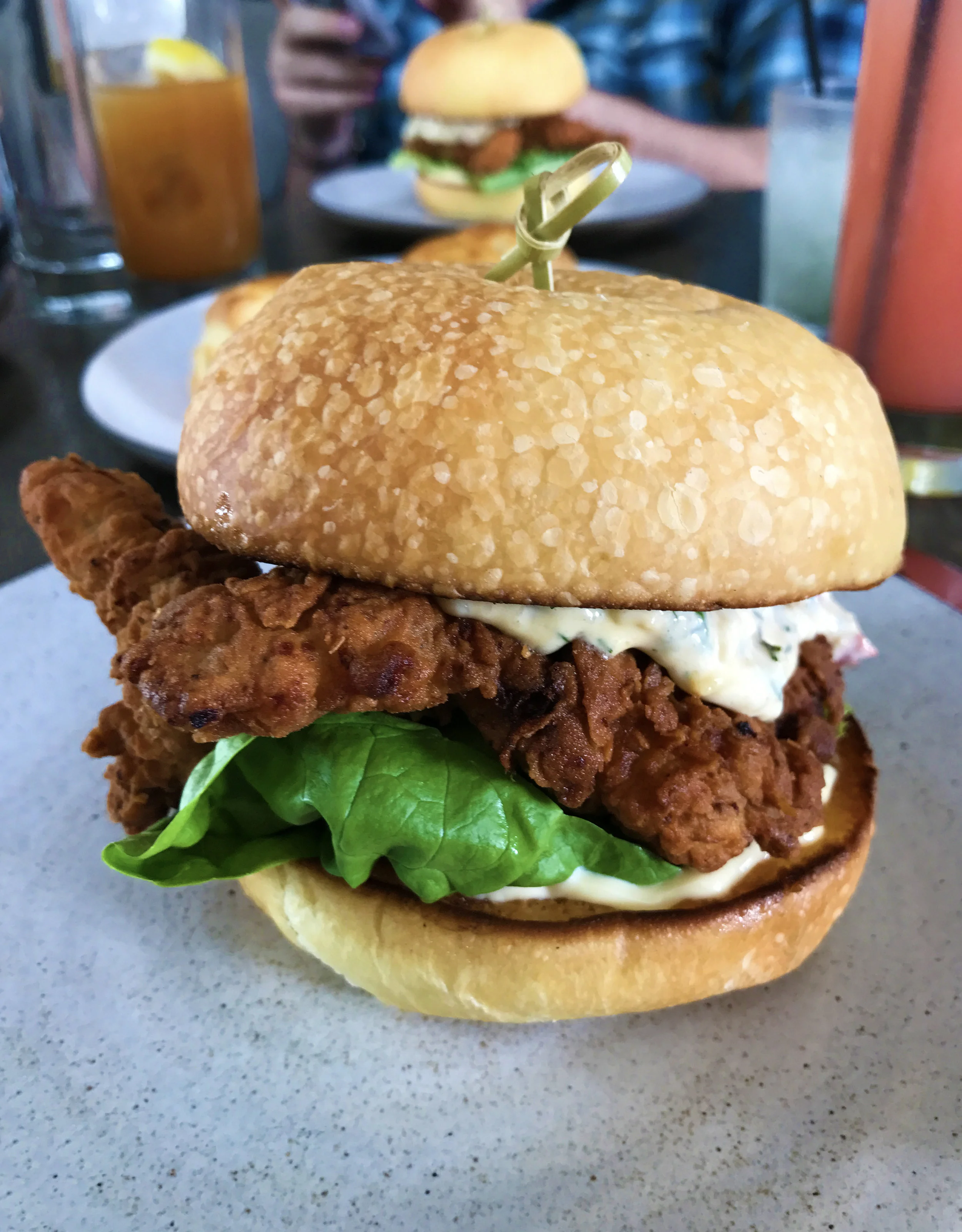 Fried chicken sandwich with crispy thighs, pimento cheese, butter lettuce, and pickles