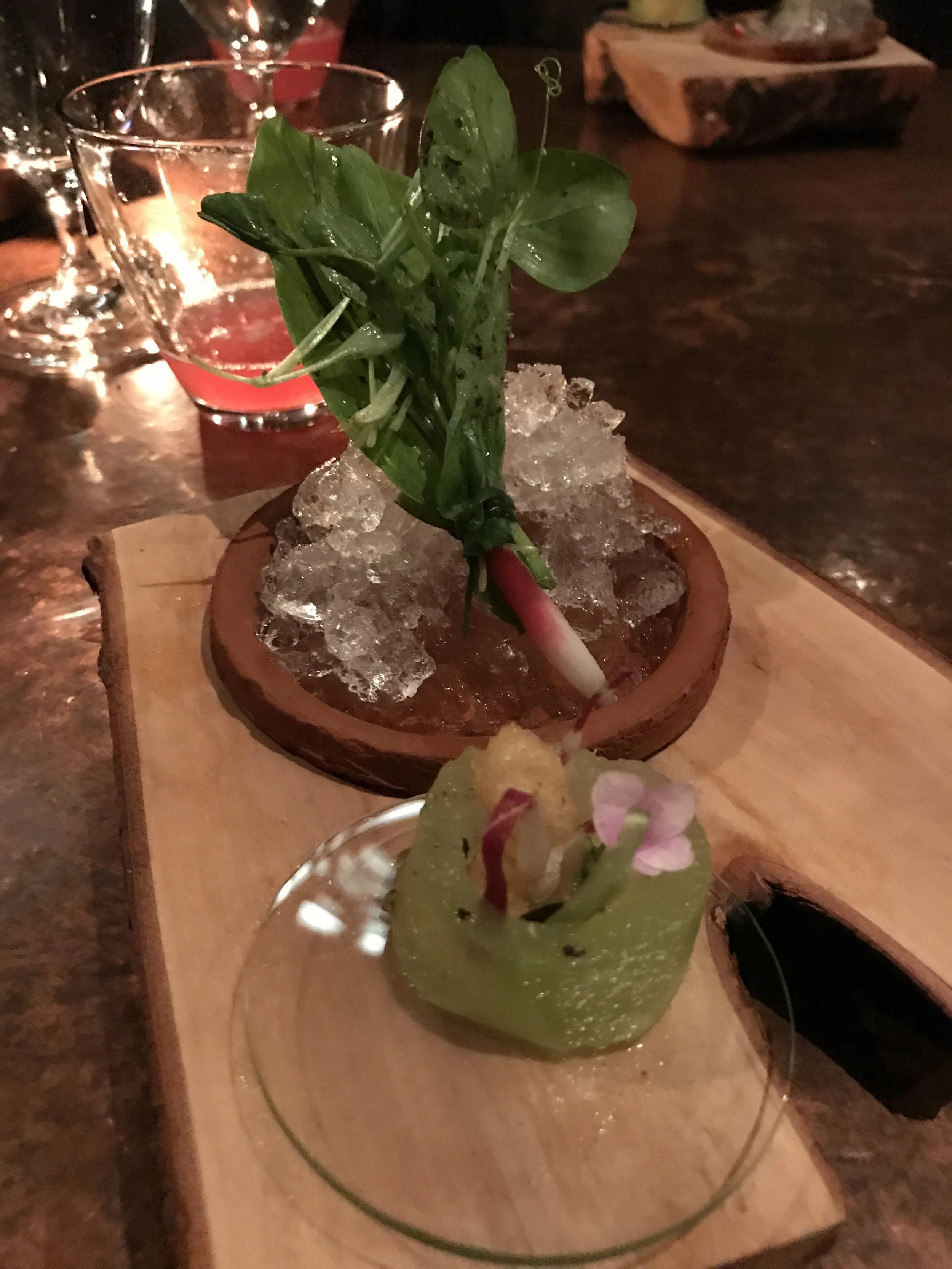 Hot and cold collection of greens: (front) cooked bitter greens inside compressed melon (back) a bundled collection of leaves with peppery and salty accents