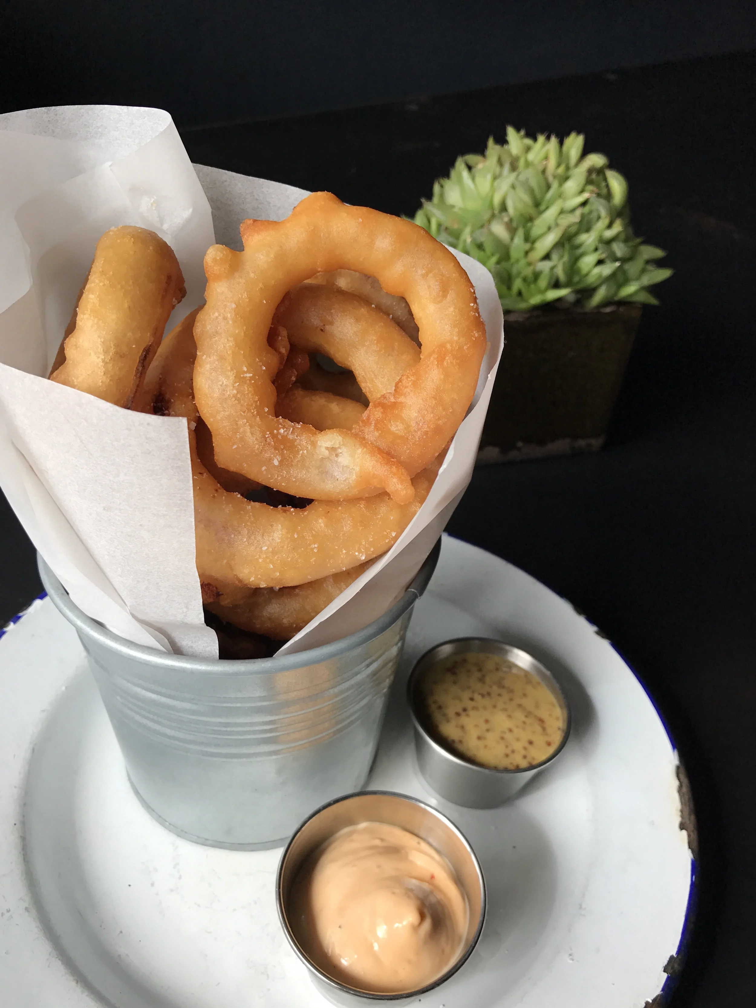 Balsamic marinated onion rings with spiced aioli and mustard