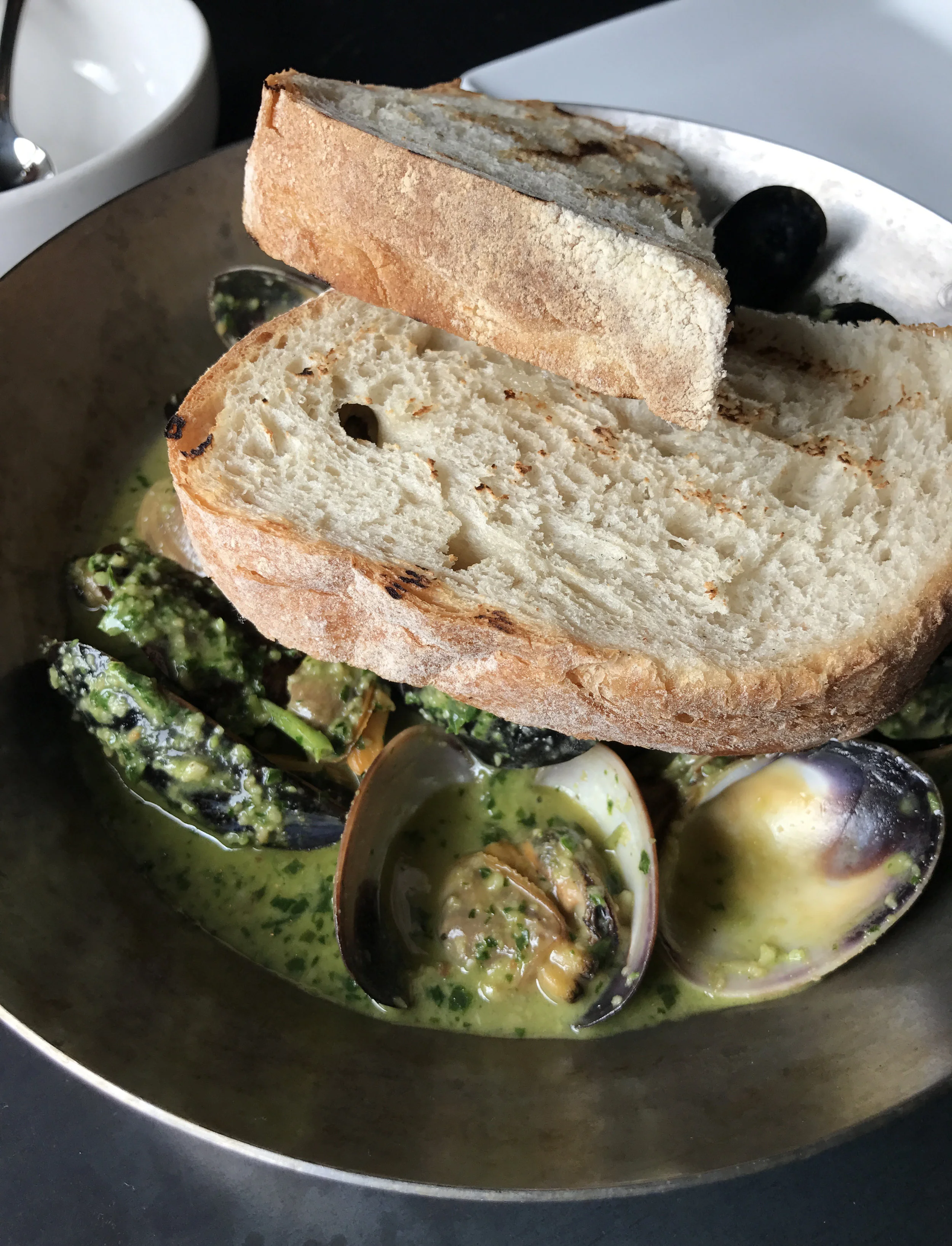 Steamed mussels and clams with serrano pesto broth with cashews and grilled country bread