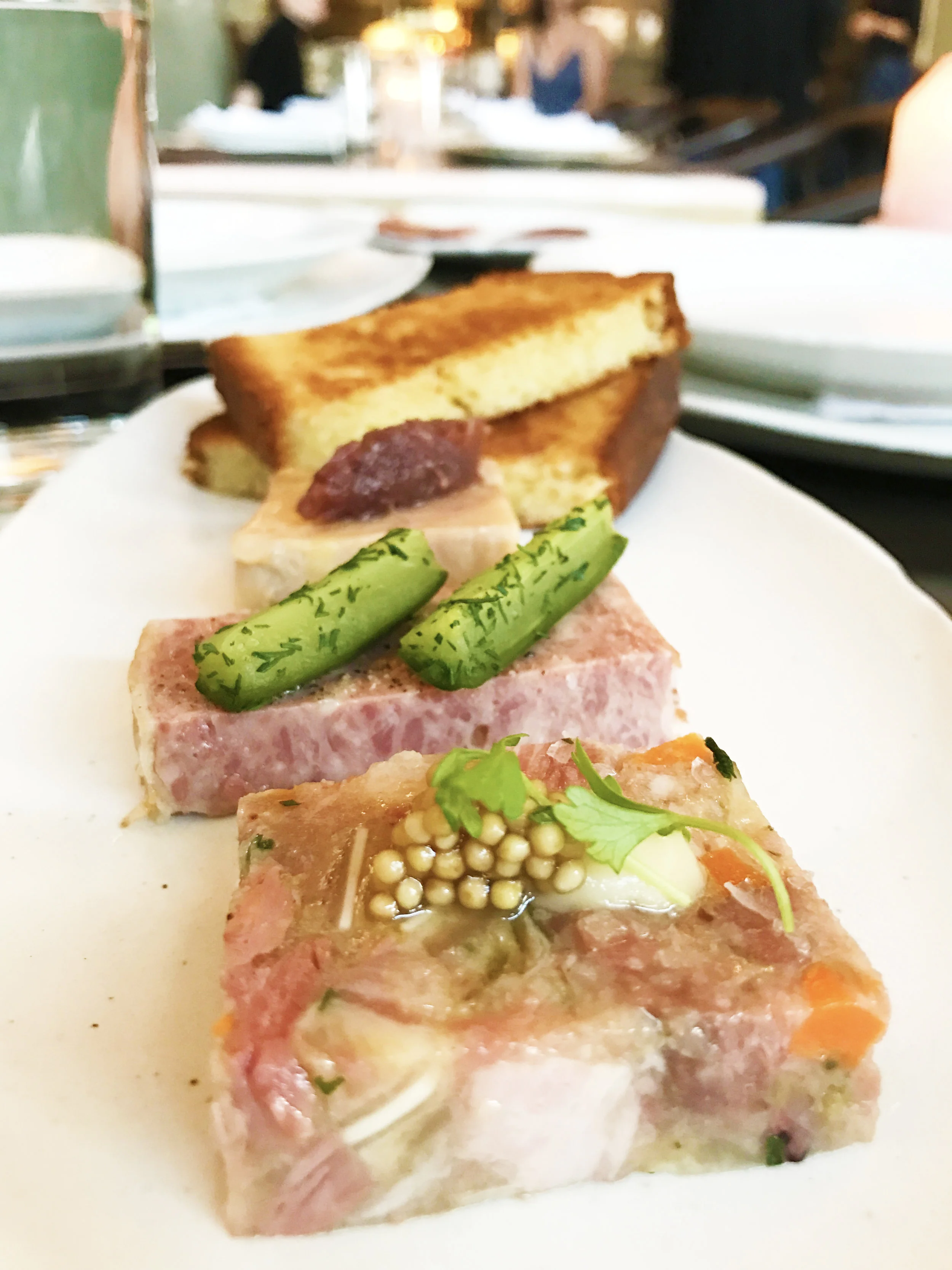 Terrines - head cheese with mustard seed (front), country rillette with pickles (middle), and foie gras (back)