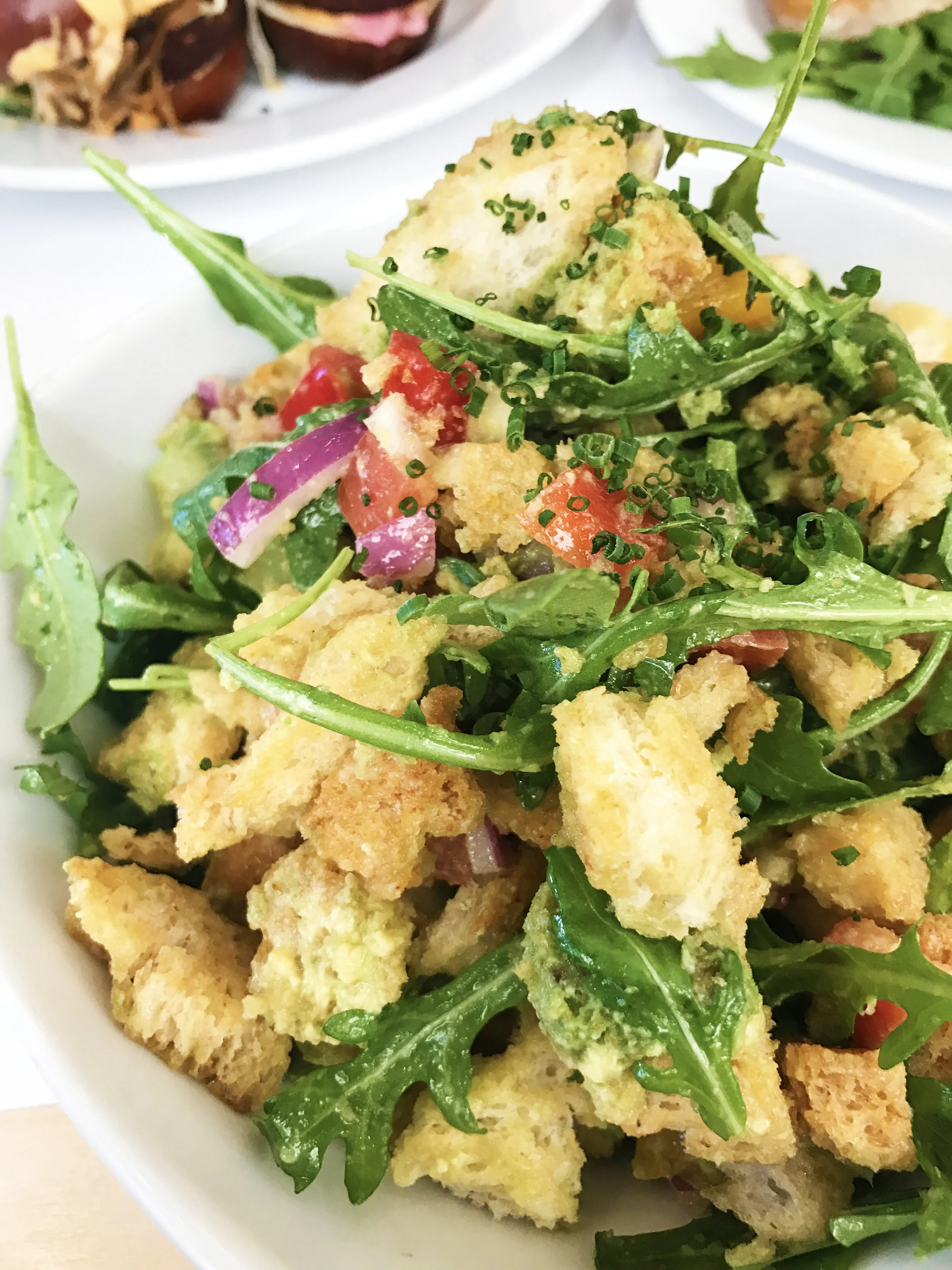 Panzanella salad with toasted bread, avocado, and market vegetables