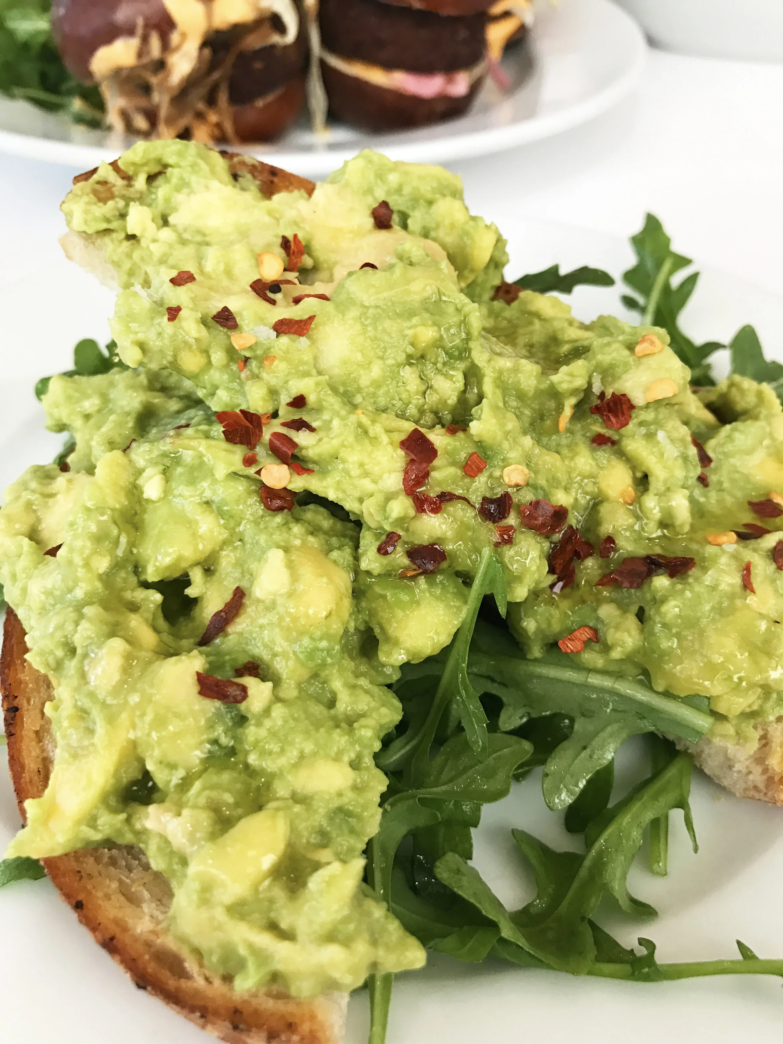 Avocado Toast with red chili flakes, lemon, olive oil, and maldon