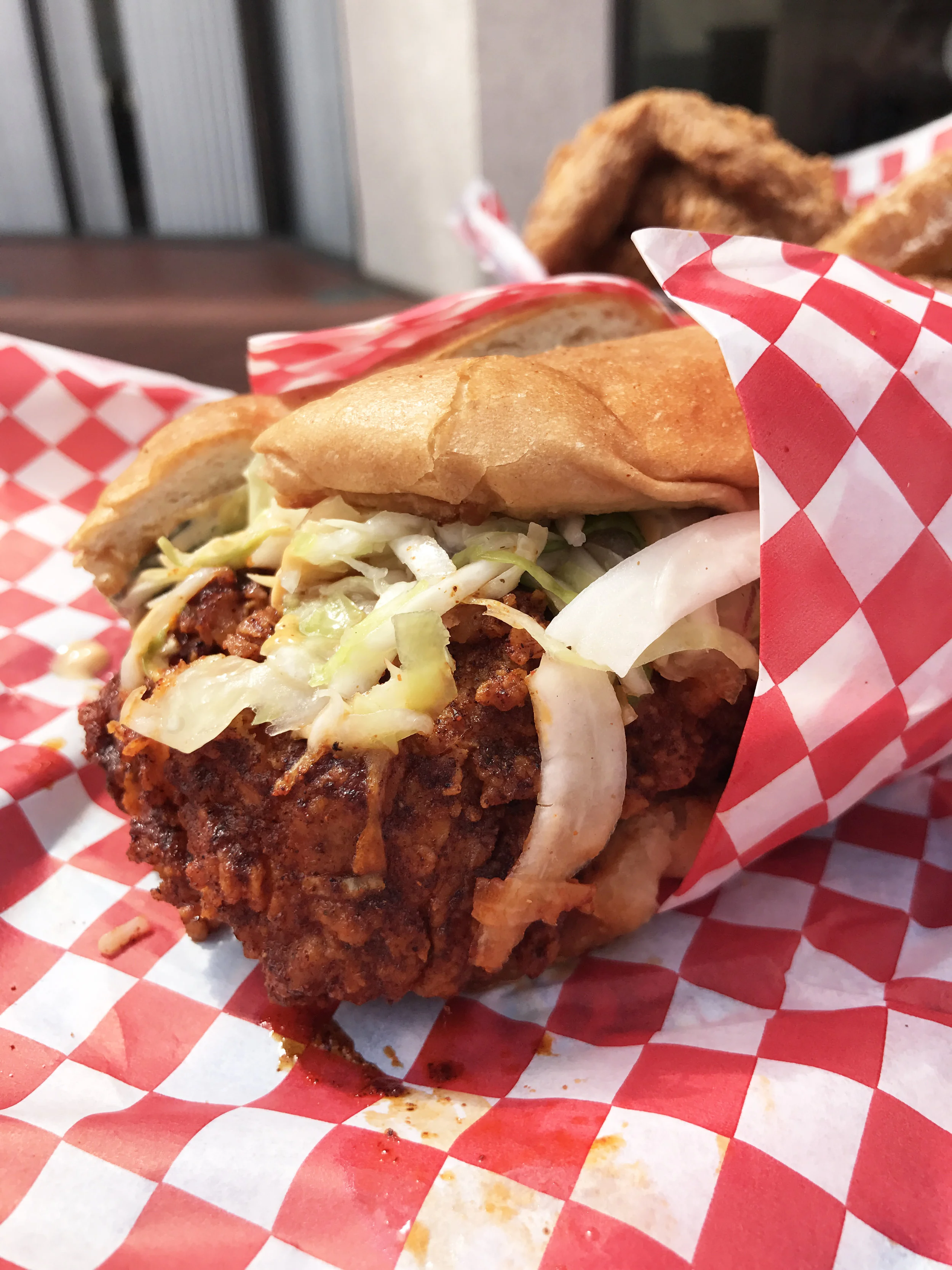 Hot Chicken Sando (Medium "feel the burn" spicy) with boneless breast, slaw, comeback sauce, pickles, on a butter bun.