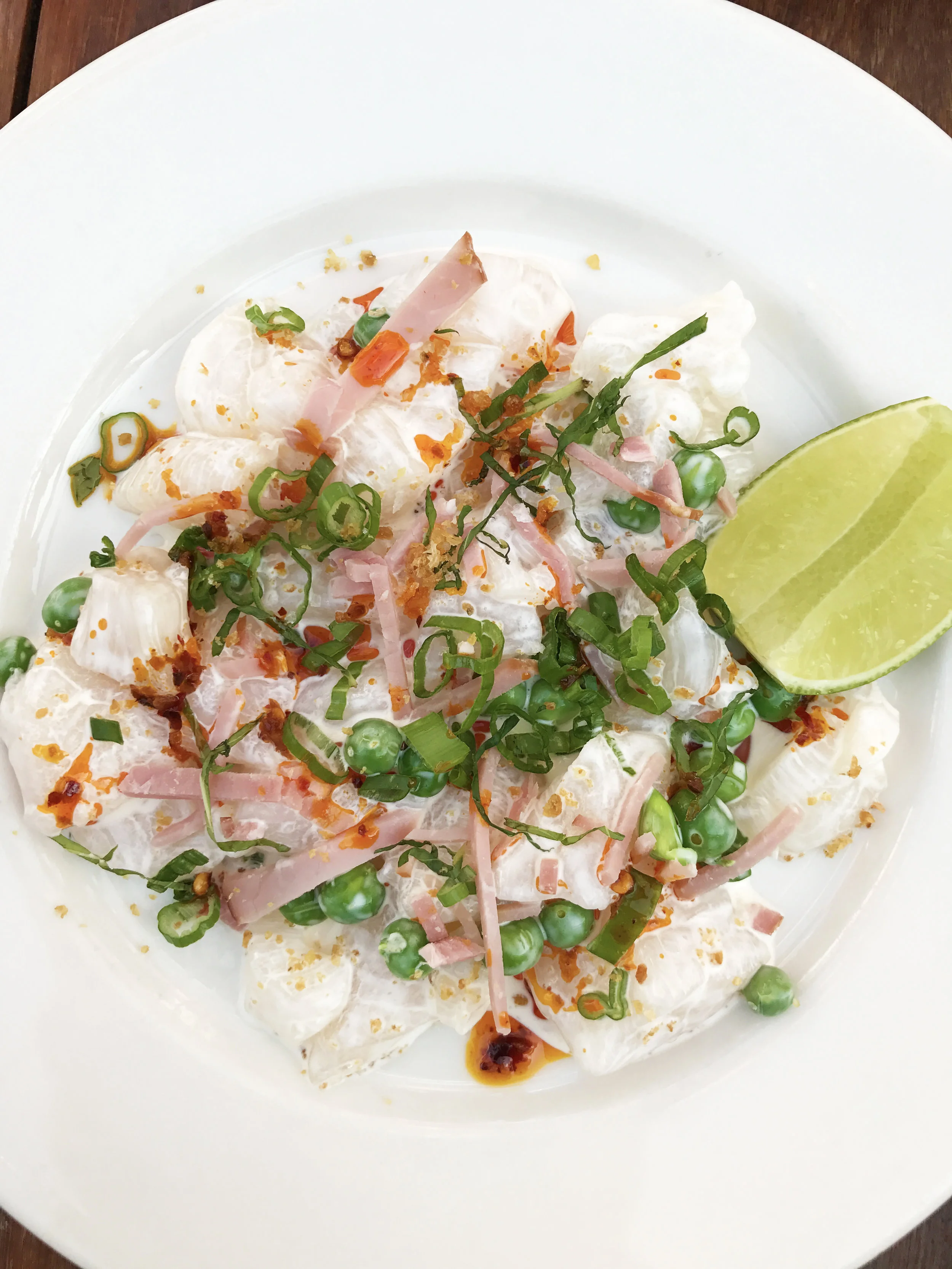Raw Spicy Scallops with dried shrimp, English peas, ham, scallions, mint, and chile oil