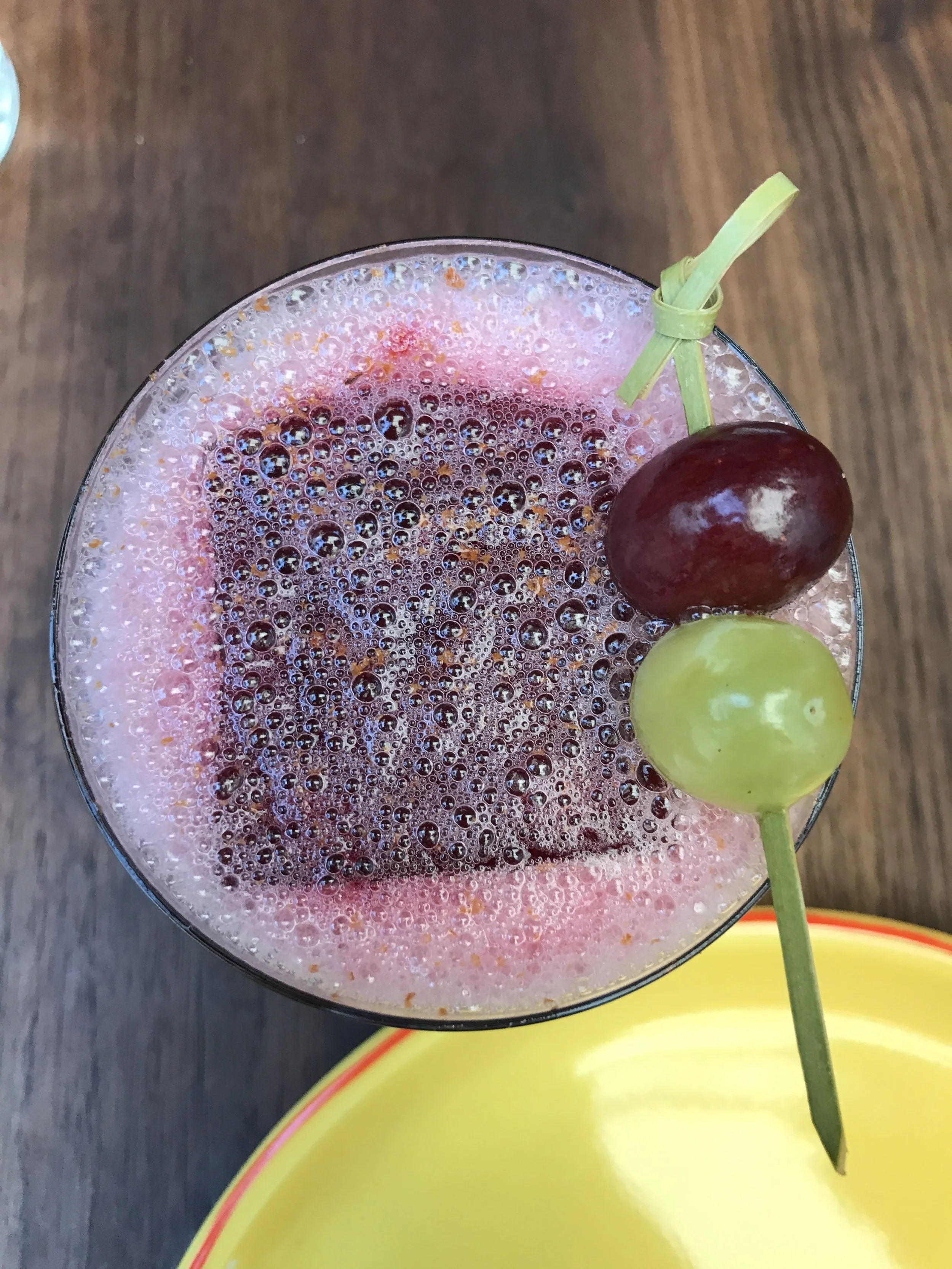 "Two Moons" with vodka, Singani 63 eau de vie, grape, lime, cinnamon, bitters, and chicha morada ice