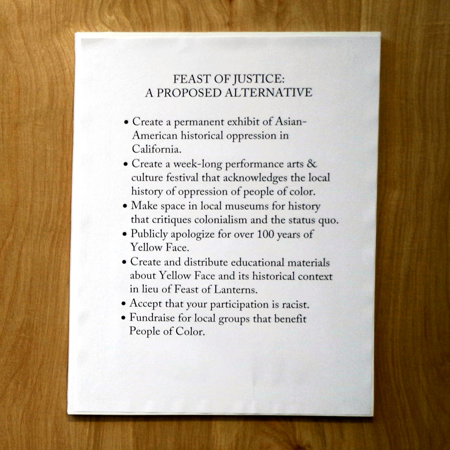 image description: a single museum board on a wooden backdrop.