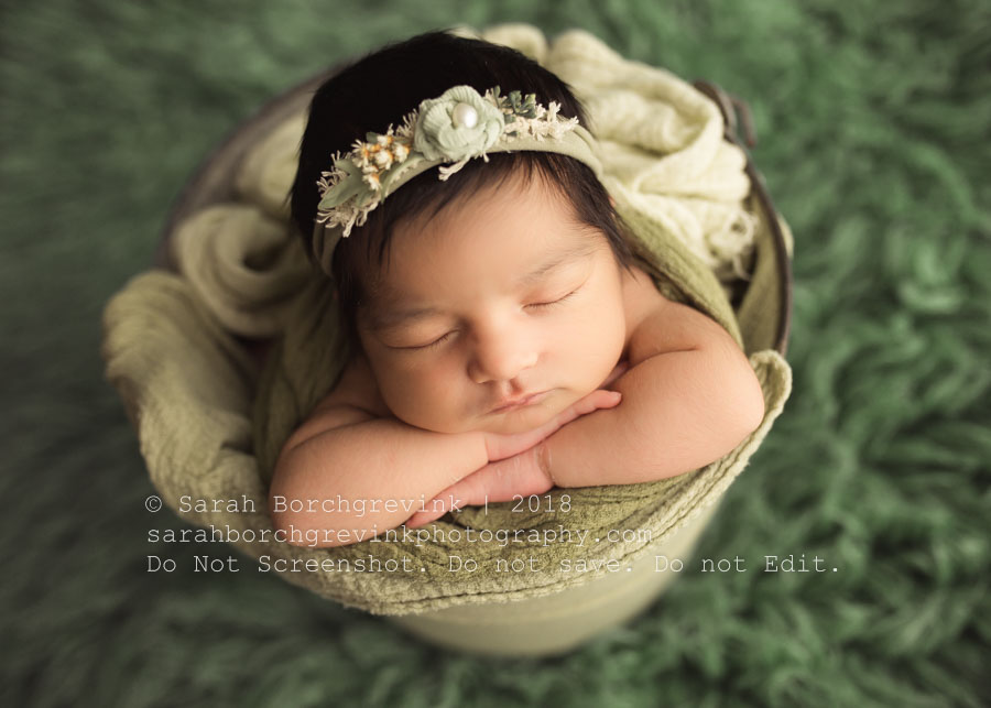 Baby in a bucket with sea foam green colors