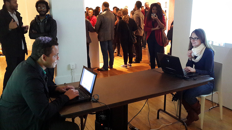Phase 2 and 3: During phase 2, gallery visitors take the performers' places and continue mediating the Chatbot conversation. In phase 3, the Chatbots spontaneously stop accepting input from the keyboard while still speaking to one another. The participant's role is eliminated and the continuing conversation is shown on the computer screens and projected onto the walls. 