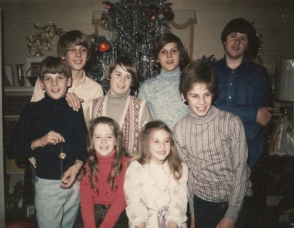  My father's side of the family - his brothers, sister and cousins at Christmas. My dad is the one in the smashing grey turtleneck!