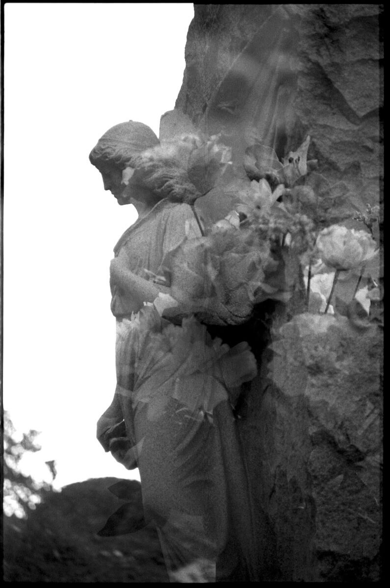 This is a double exposure of my favorite statue in the cemetery and some flowers. This is the same statue as the first photo in this post.
