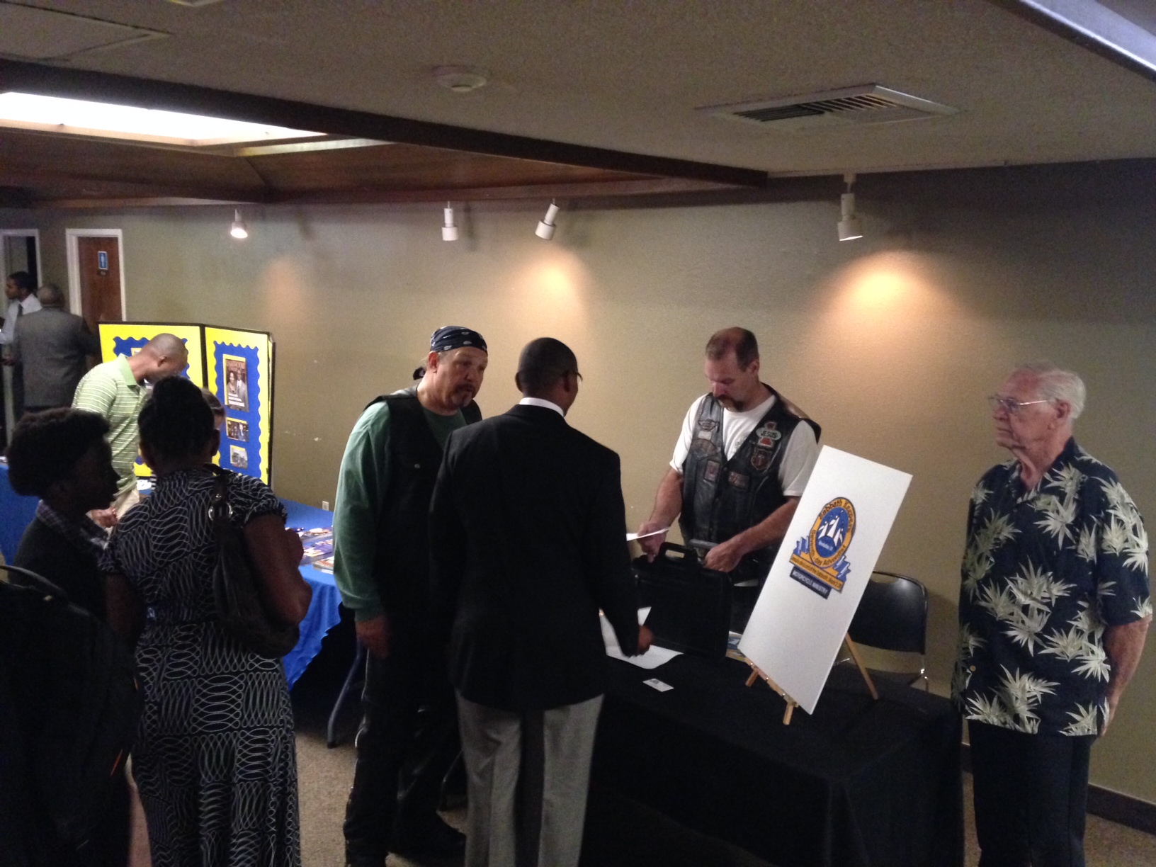 SKMM booth set up at Mt. Rubidoux SDA Church. From left to right: Russ Nelson (du-rag), Patrick Green, Jerry Booker (Terry Booker's father).