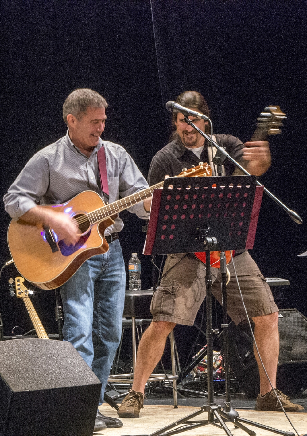 Photo By Tom Brenner Victor Hogg and I playing at A Musical Concert Voices Of War at Housatonic Community College in the fall of 2016. One of the perks of my job is to have the opportunity to perform on stage with some very talented musicians. Click the image to connect to a video clip for a rehearsal for a Warren Zevon Tribute Concert from 2013.
