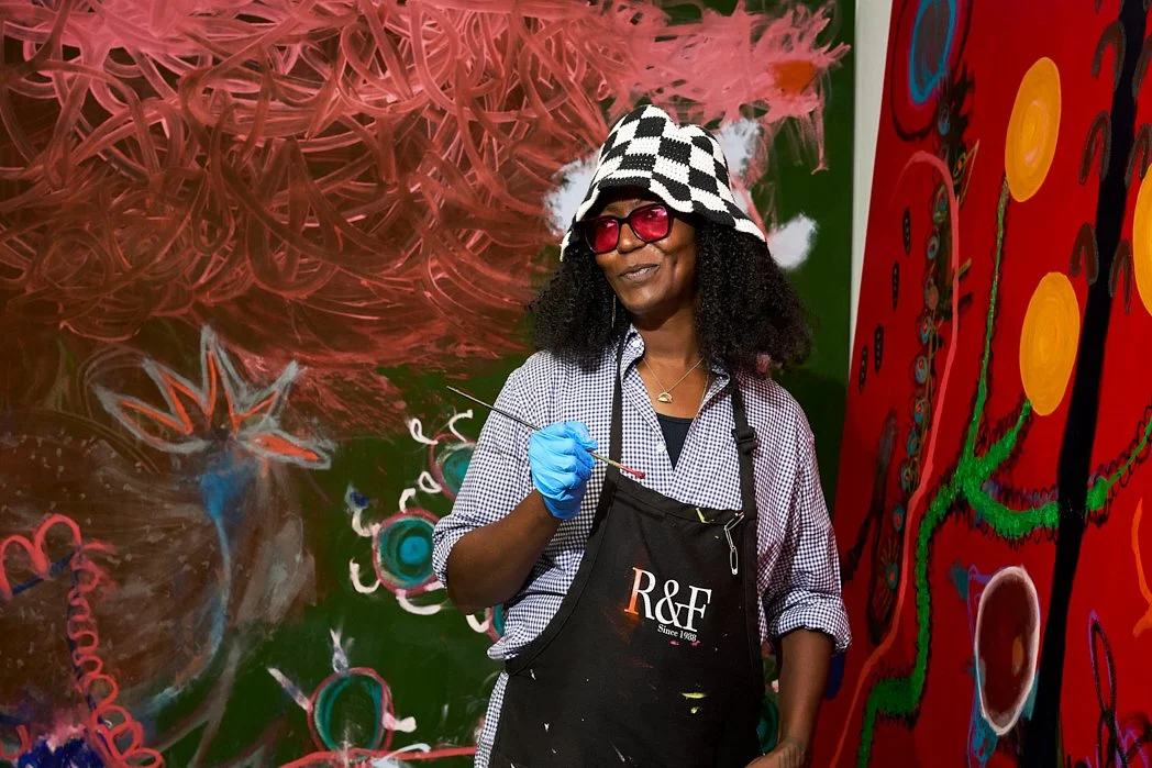 Editorial portrait of painter Uman in her studio surrounded by her vivid abstract work, photographed by Christopher Garcia Valle