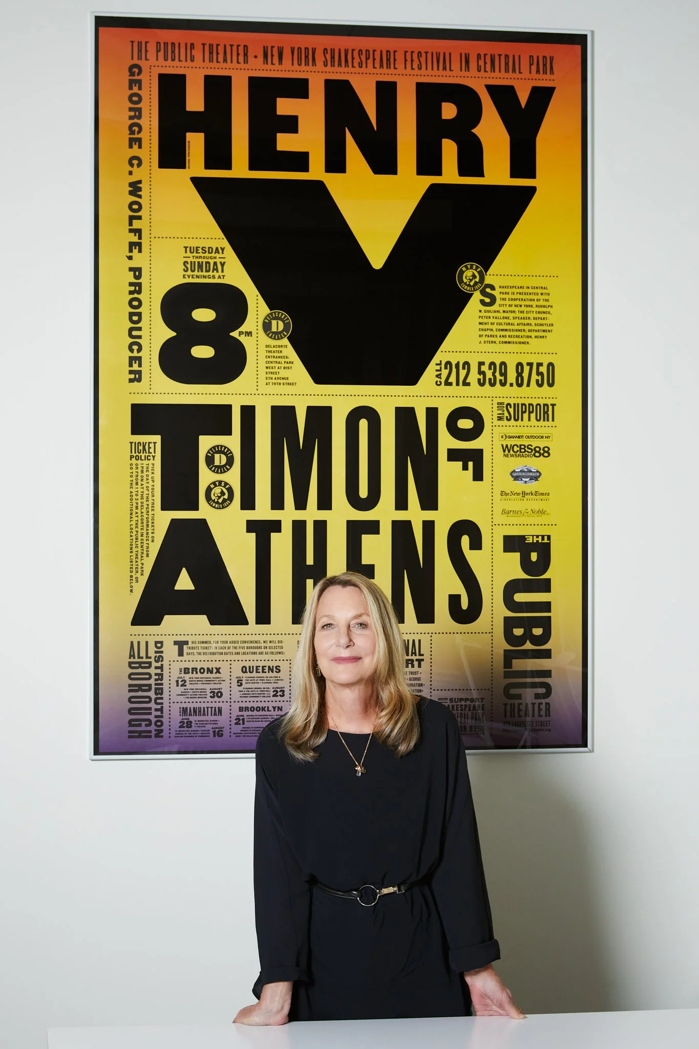 Editorial portrait of graphic designer Paula Scher at Pentagram, New York, before one of her Public Theater posters, photographed by Christopher Garcia Valle