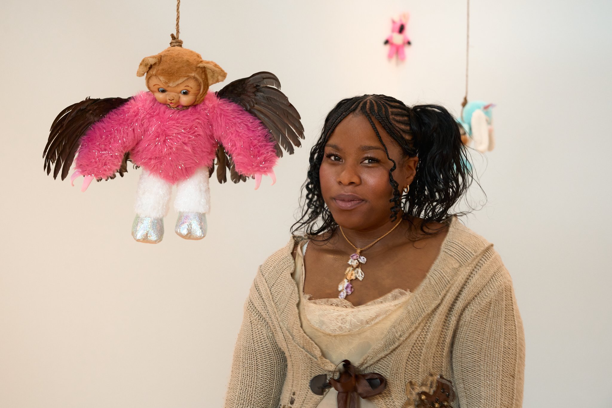 Editorial portrait of artist Precious Okoyomon with their suspended sculptural works at the Whitney Biennial, photographed by Christopher Garcia Valle