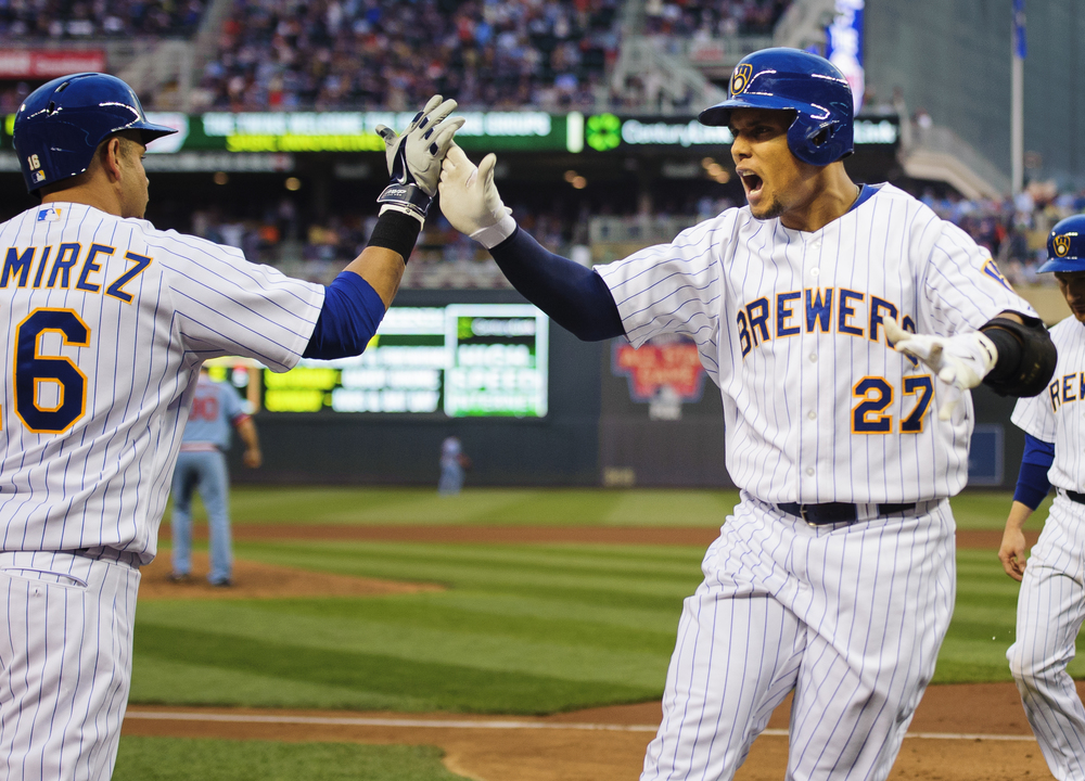  Carlos Gomez #27 of the Milwaukee Brewers is congratulated by Aramis Ramirez #16 on his three-run home run against the Minnesota Twins during the fourth inning of the game on June 5, 2014 at Target Field in Minneapolis, Minnesota.   (Photo by Hannah