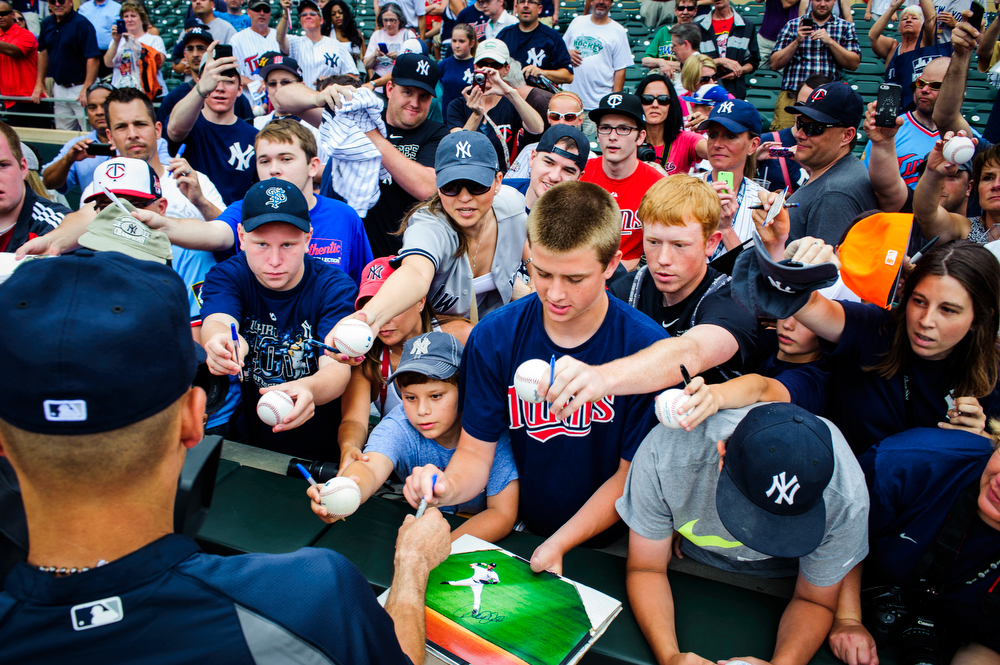  MINNEAPOLIS, MN - JULY 6: Derek Jeter #2 of the New York Yankees signs autographs for fans before the game against the Minnesota Twins on July 6, 2014 at Target Field in Minneapolis, Minnesota.  (Photo by Hannah Foslien/Getty Images)  