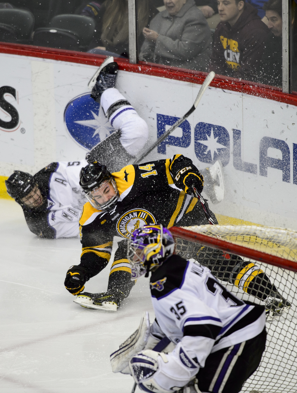  Stephon Williams #35 of Minnesota State watches as Carter Foguth #5 of Minnesota State and Malcolm Gould #14 of Michigan Tech slide into the boards during the first period of the 2015 WCHA Final Five hockey championship game on March 21, 2015 at Xce
