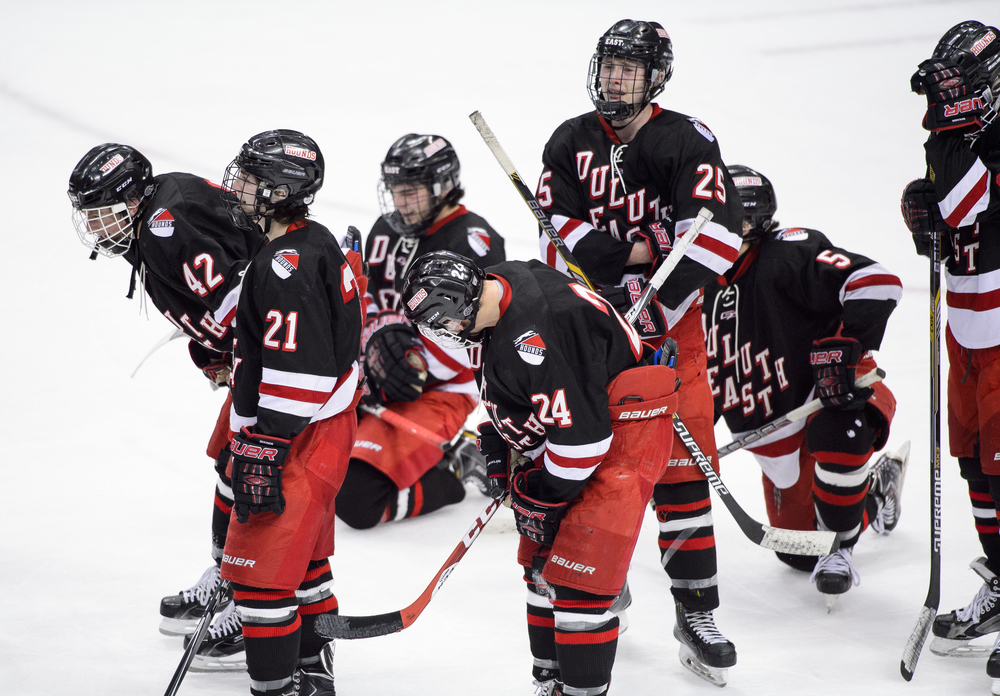  Duluth East forward Matt Lyttle (23), left, forward Ryan Peterson (24), defenseman Luke LaMaster (25) and forward Garret Worth (5) react after a loss to Lakeville North of the boys' Class AA state hockey tournament championship game in St. Paul, Min