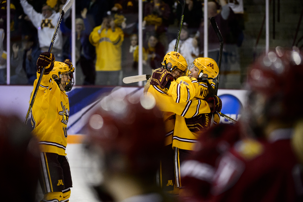  Minnesota forward Cara Piazza (10), left, defenseman Rachel Ramsey (5), and Megan Wolfe (12) celebrate a goal by Wolfe as the Harvard bench watches during the first period of an NCAA women's Frozen Four championship college hockey game Sunday, March
