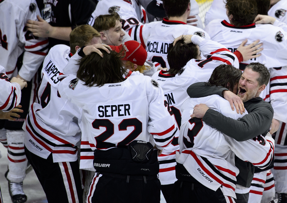  Lakeville North head coach Trent Eigner, right, celebrates a win against Duluth East with forward Jack Poehling (3) after the boys' Class AA state hockey tournament championship game in St. Paul, Minn., Saturday, March 7, 2015. Lakeville North won 4