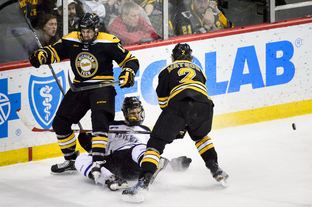  ST PAUL, MN - MARCH 21: Riley Sweeney #17 of Michigan Tech, Teddy Blueger #23 of Minnesota State and Cliff Watson #2 of Michigan Tech collide during the third period of the 2015 WCHA Final Five hockey championship game on March 21, 2015 at Xcel Ener