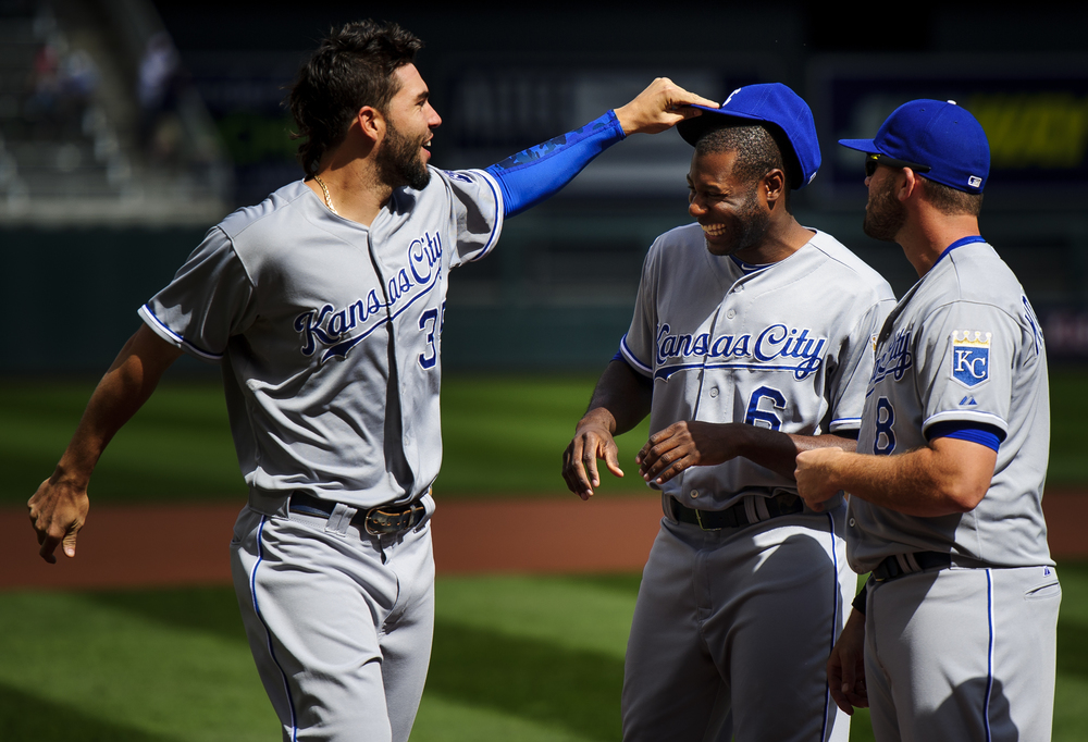  (L-R) Eric Hosmer #35 and Lorenzo Cain #6 of the Kansas City Royals joke around as Mike Moustakas #8 and Alcides Escobar #2 looks on while they line up before the home opening game for the Minnesota Twins on April 13, 2015 at Target Field in Minneap