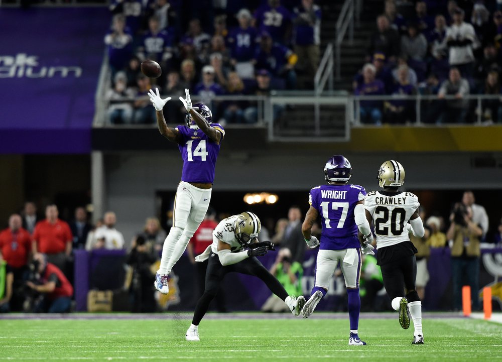  Stefon Diggs #14 of the Minnesota Vikings leaps to catch the ball in the fourth quarter of the NFC Divisional Playoff game against the New Orleans Saints on January 14, 2018 at U.S. Bank Stadium in Minneapolis, Minnesota. Diggs scored a 61-yard touc