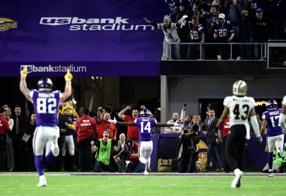  Stefon Diggs #14 of the Minnesota Vikings runs with the ball to score a touchdown as time expired in the NFC Divisional Playoff game against the New Orleans Saints on January 14, 2018 at U.S. Bank Stadium in Minneapolis, Minnesota. The Vikings defea