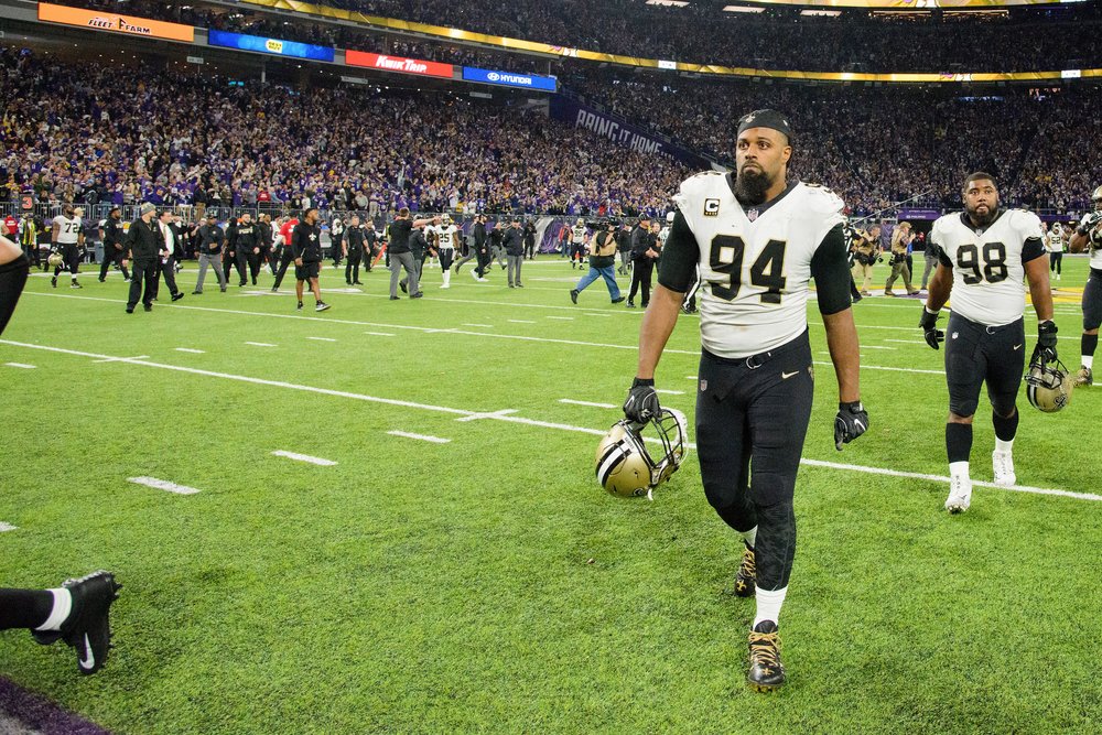  Cameron Jordan #94 and Sheldon Rankins #98 of the New Orleans Saints walk off the field after the NFC Divisional Playoff game against the Minnesota Vikings on January 14, 2018 at U.S. Bank Stadium in Minneapolis, Minnesota. The Vikings defeated the 