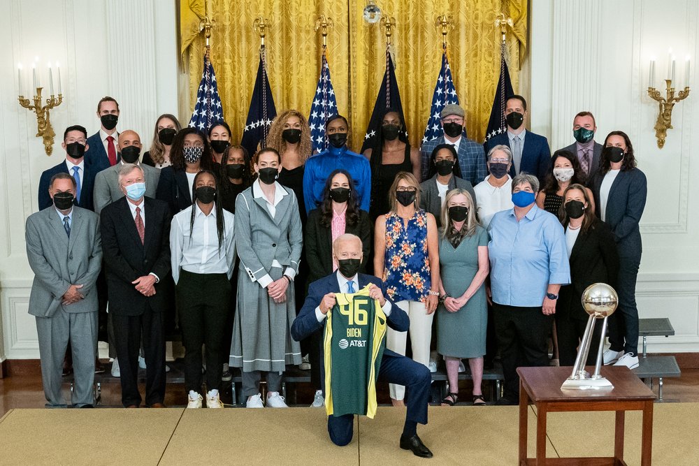  President Joe Biden poses for a team photo during a ceremony in honor of the 2020 WNBA Championship Team the Seattle Storm, Monday, Aug. 23, 2021, in the East Room of the White House.   (Official White House Photo by Hannah Foslien)  