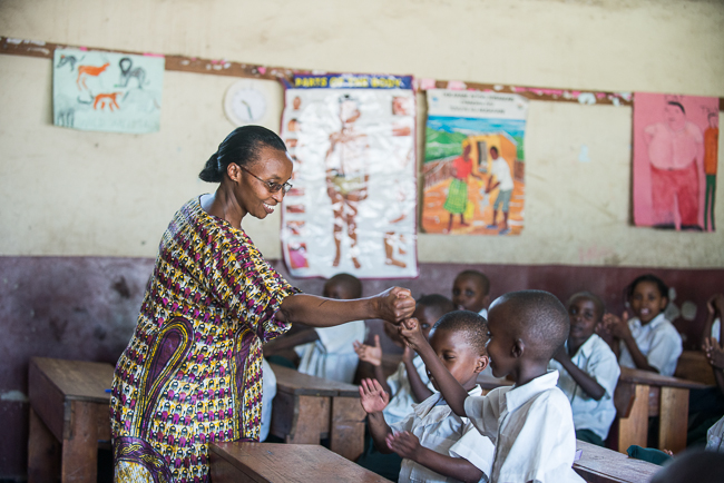 ©2014 Ni Nyaminga/Girl Hub. All Rights Reserved. Floride Basabose celebrates a correct answer with her students. Her school was built by a group of mothers who were determined that the children get a better education.