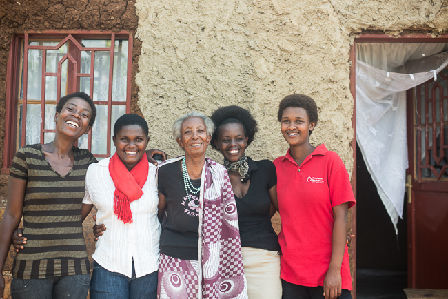 ©2014 Ni Nyaminga/Girl Hub. All Rights Reserved. Cecile Mukarugaza poses in front of the house that was built for her by an association of students who help vulnerable people.