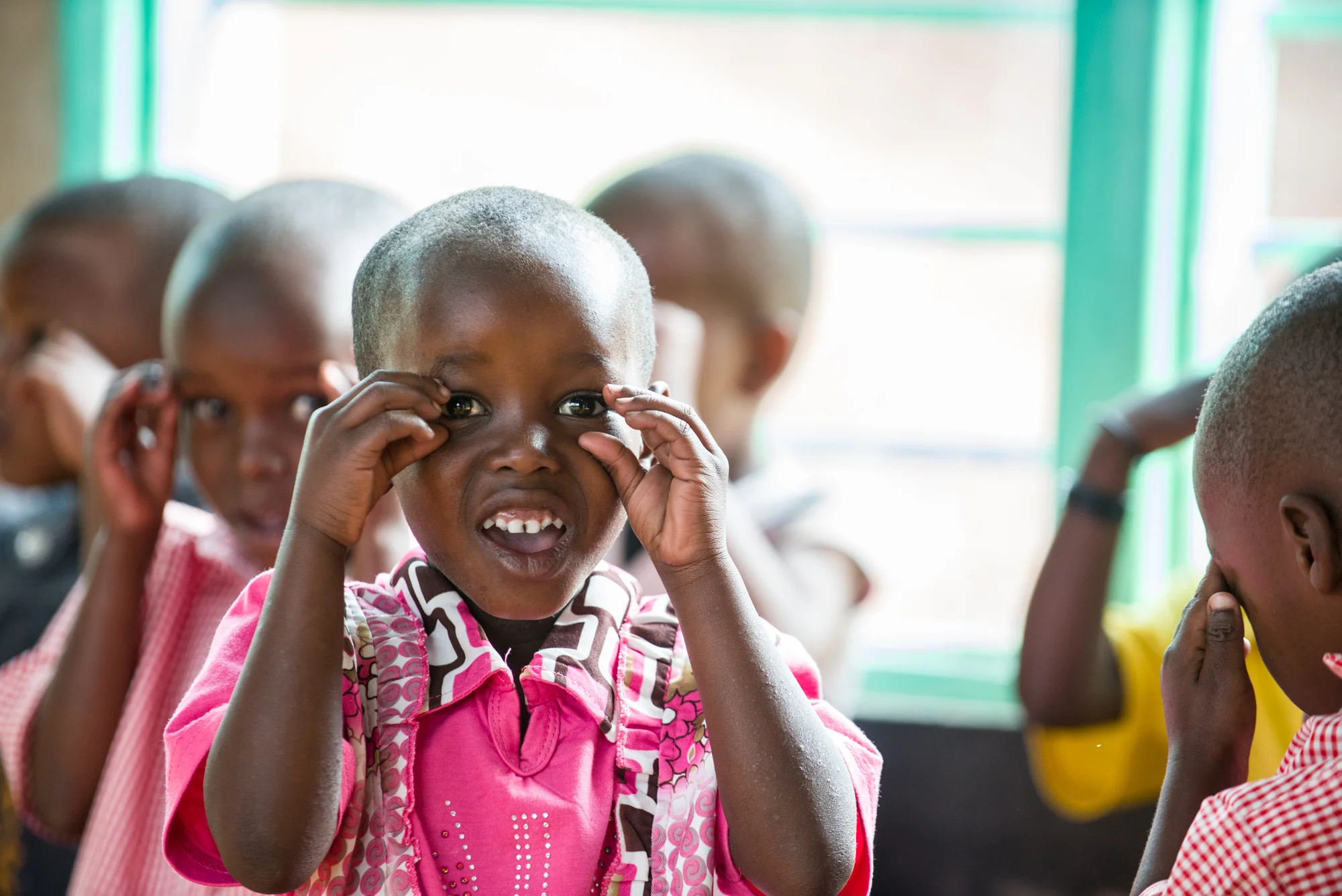 Marceline Karabo, age 4, sings a song with her pre-primary classmates and Kanyinya School in Rwanda.