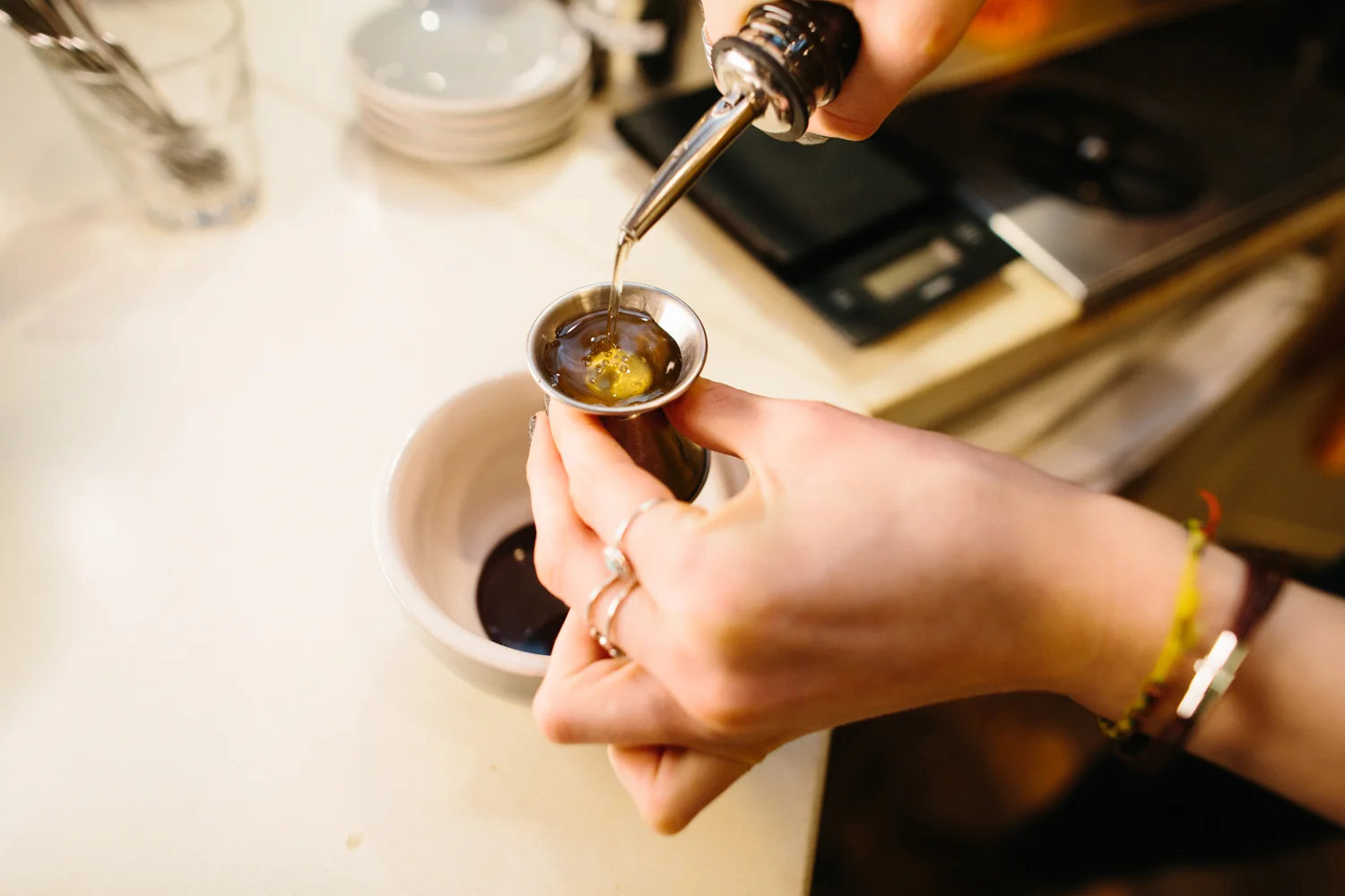 Image of a barist pouring mint syrup