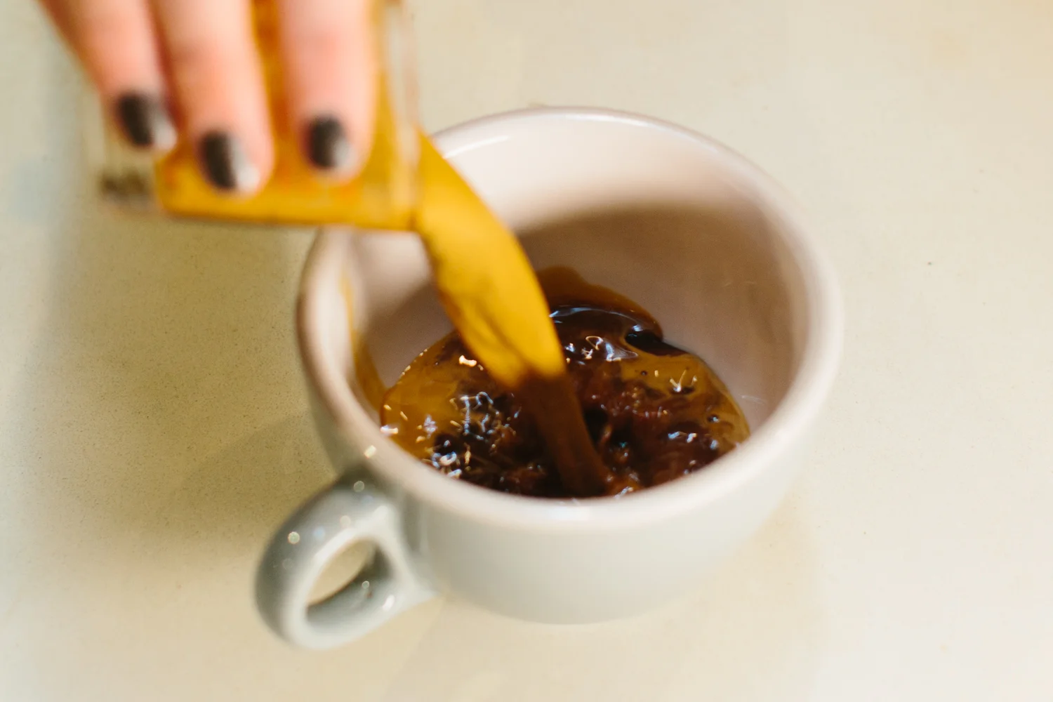 Image of espresso pouring into a mug