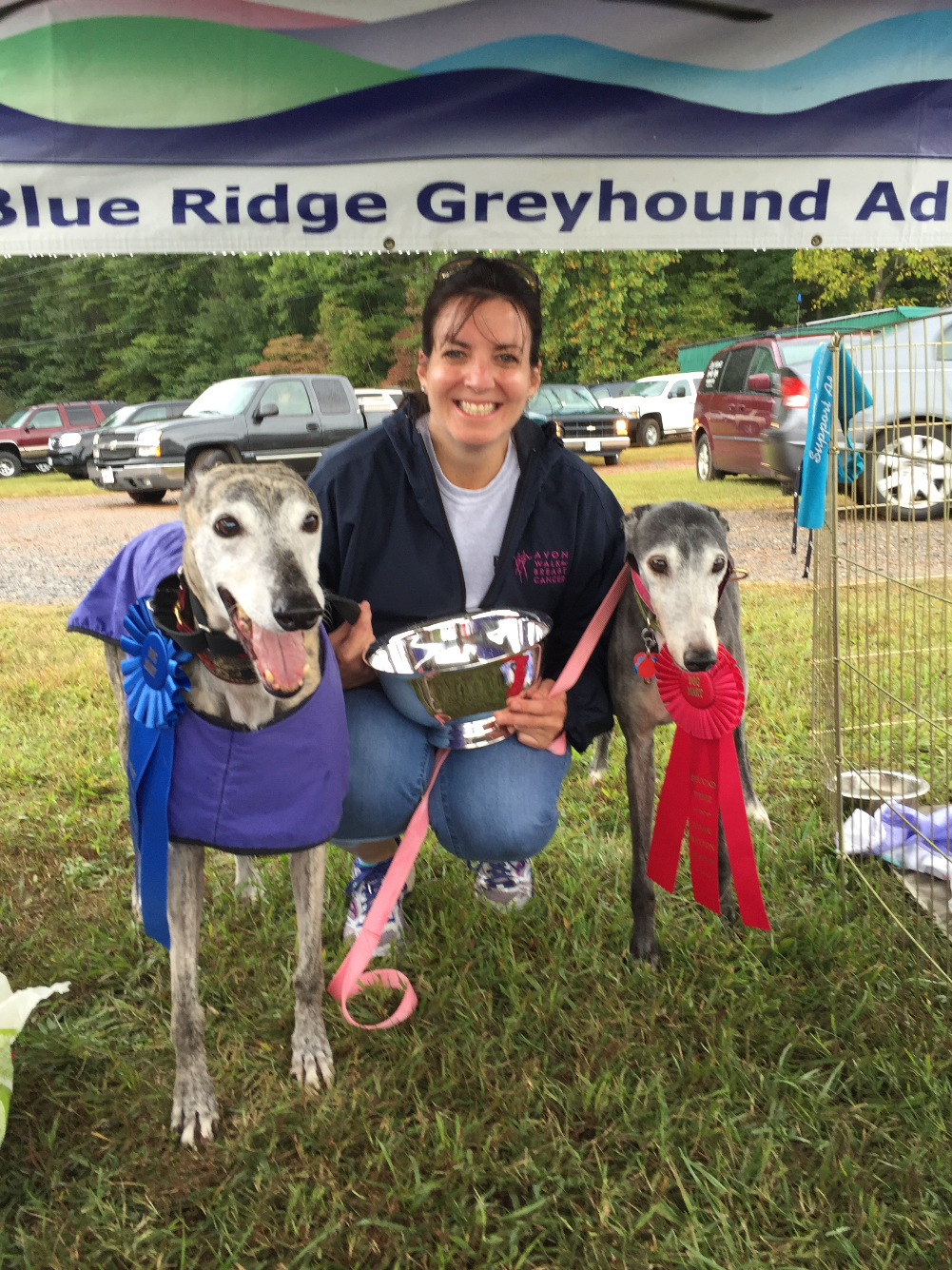 Gracie with her blue ribbon and silver Best in Show bowl, and Lollipop with her red ribbon.